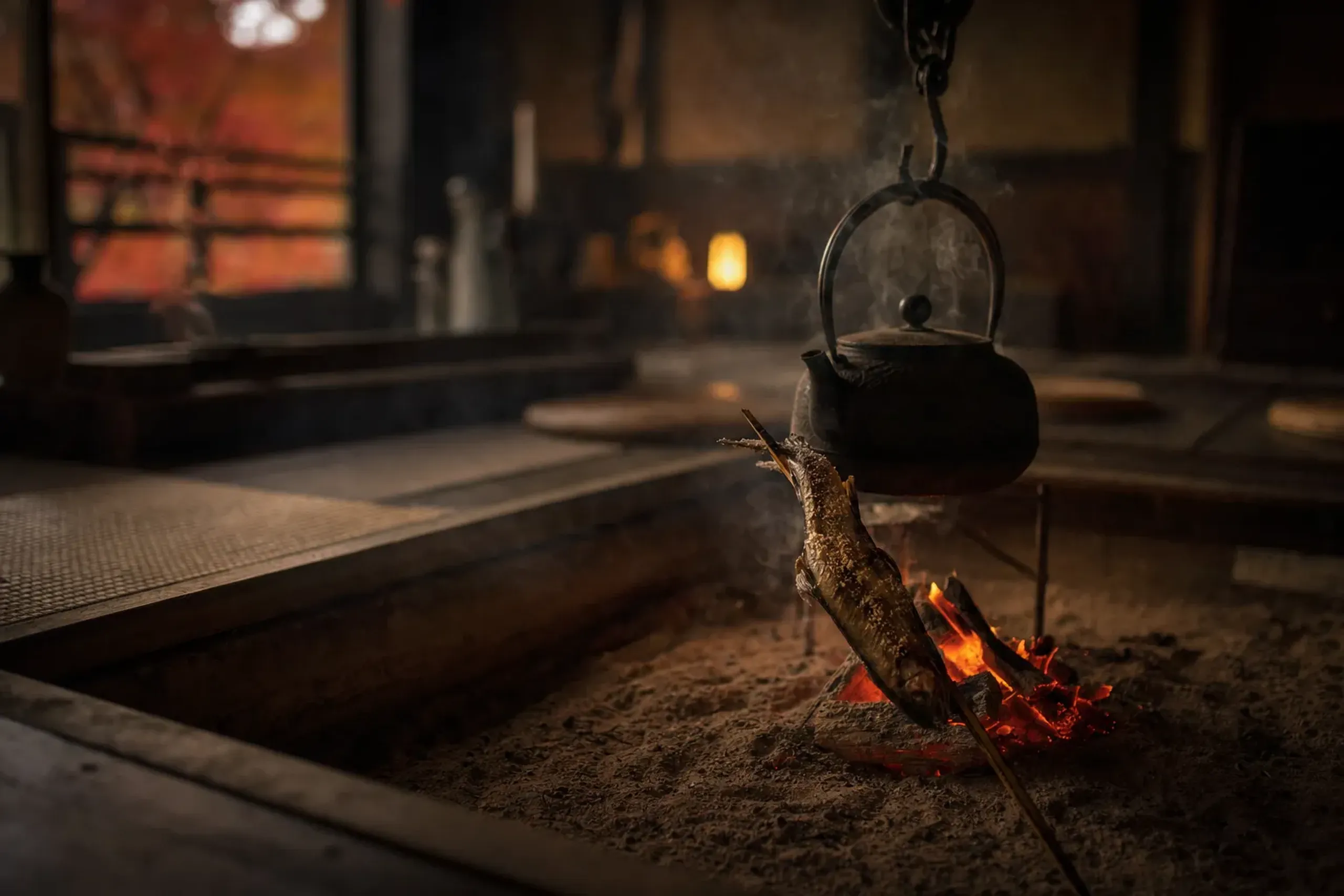 a meal being prepared over the glowing embers of the irori open hearth in the thatched farmhouse dining room