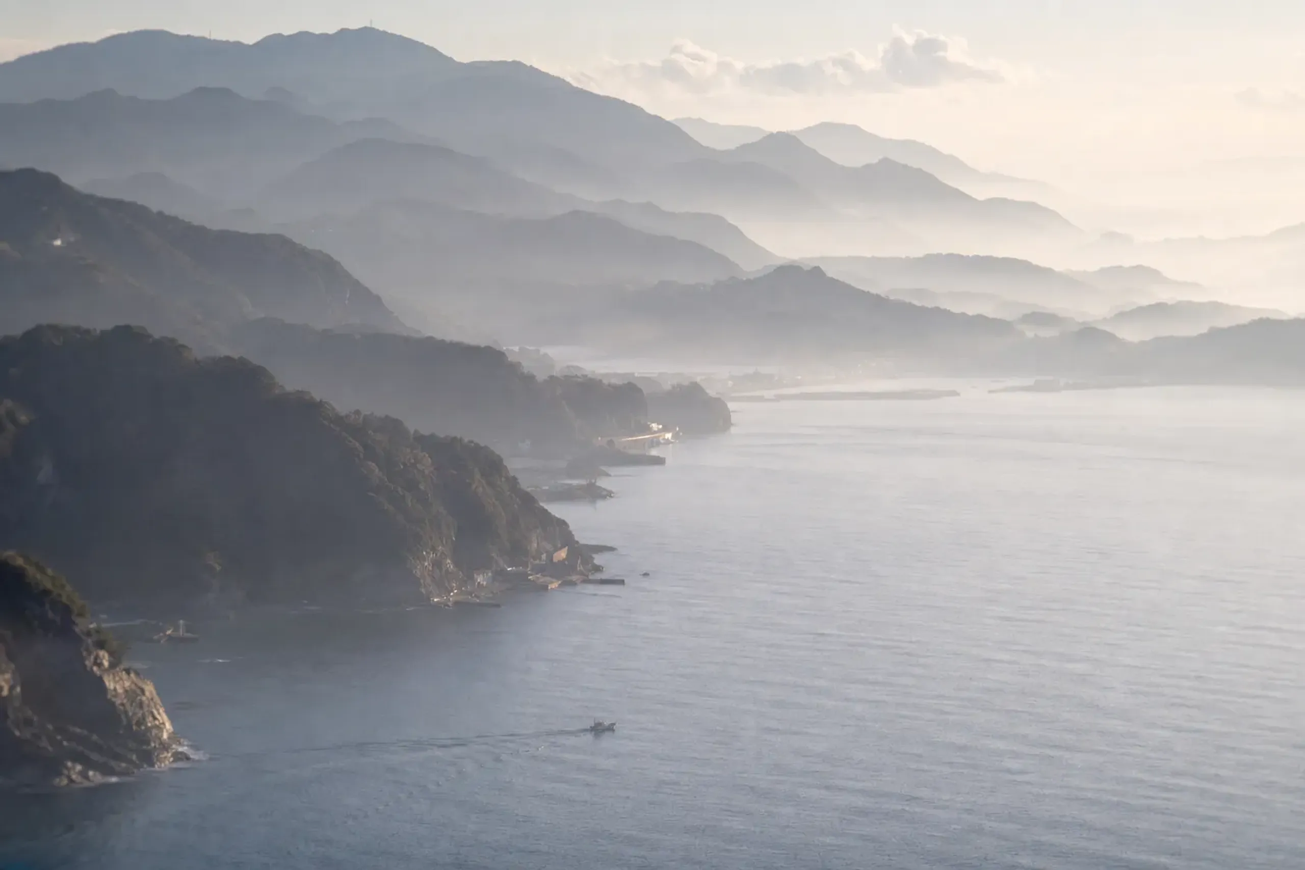 The misty hills folding inward around Shimoda Bay in the early morning quiet
