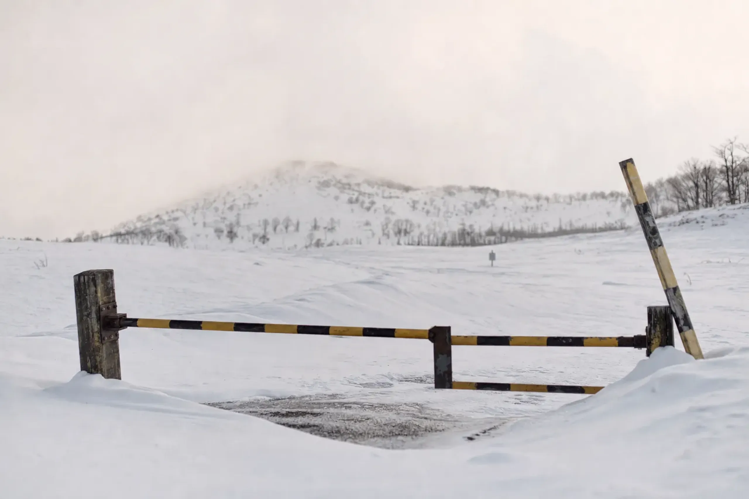 the snow-buried, closed Shiretoko Pass road (National Route 334) under deep winter snow accumulation