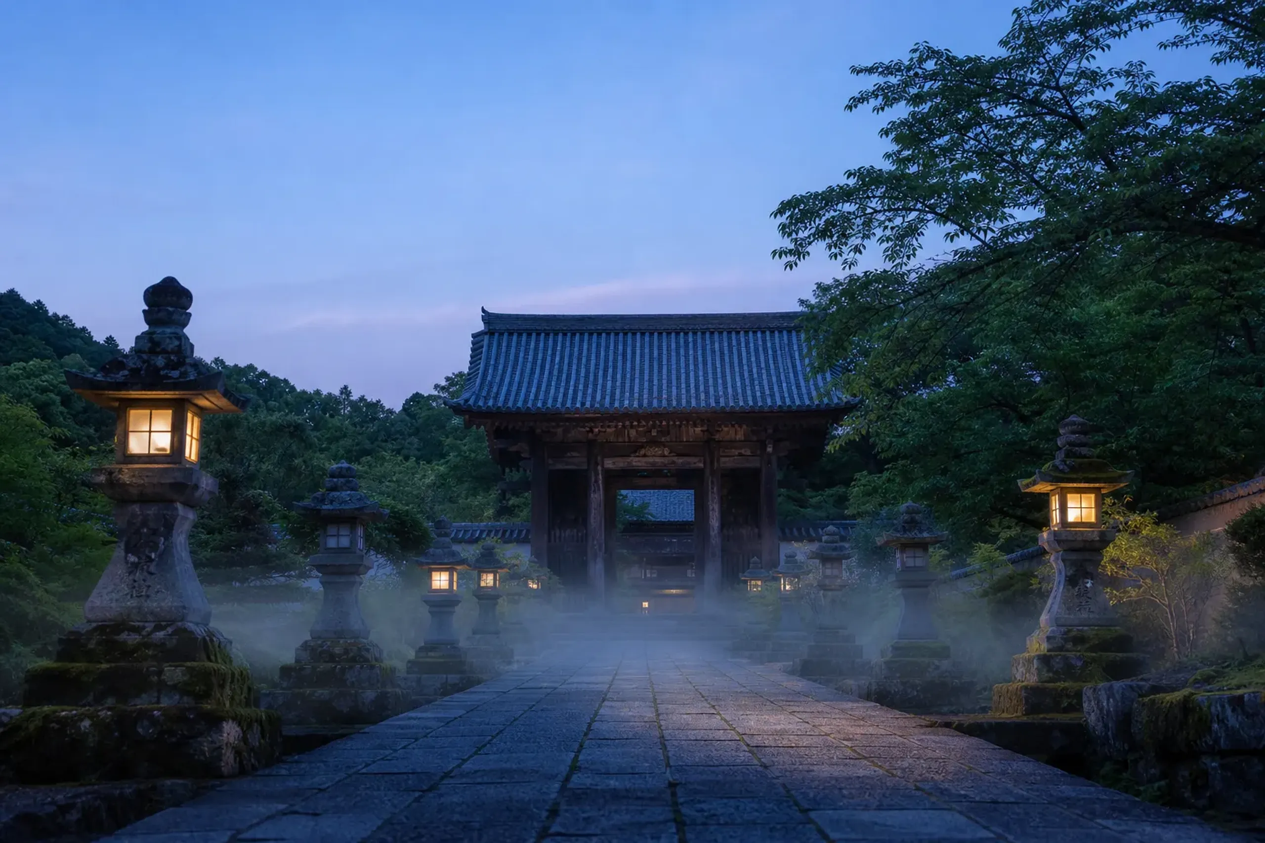 Empty Kyoto temple pathway at dawn with stone lanterns and a wooden gate