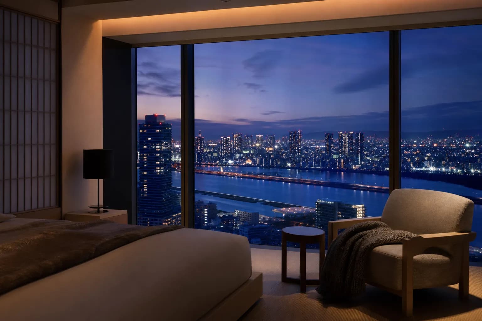 Luxury Osaka hotel room at dusk with large windows overlooking the illuminated city skyline