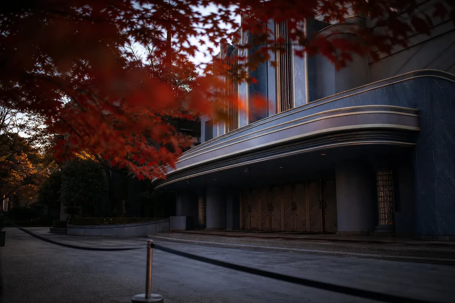 The exterior facade of Universal Studios Japan's Cinema 4-D Theater in Osaka, its marquee signage and covered entrance canopy set against an empty plaza in the low-crowd early-morning window