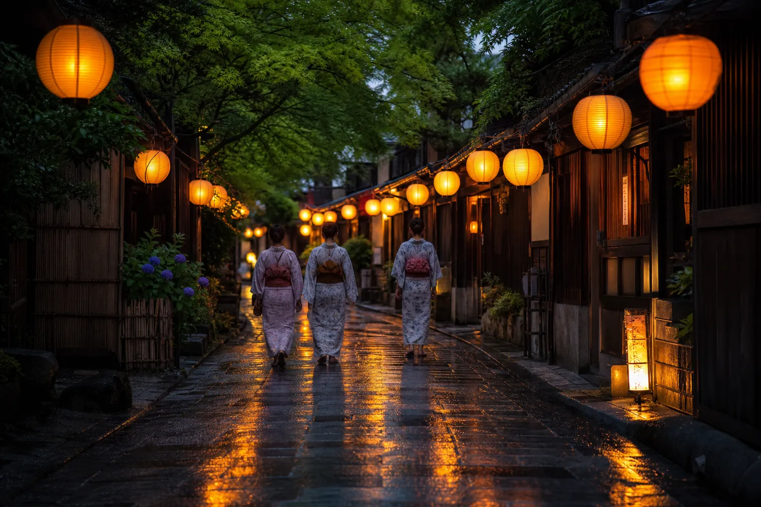 Quiet lantern-lit Kyoto lane during Gion Matsuri with people in yukata