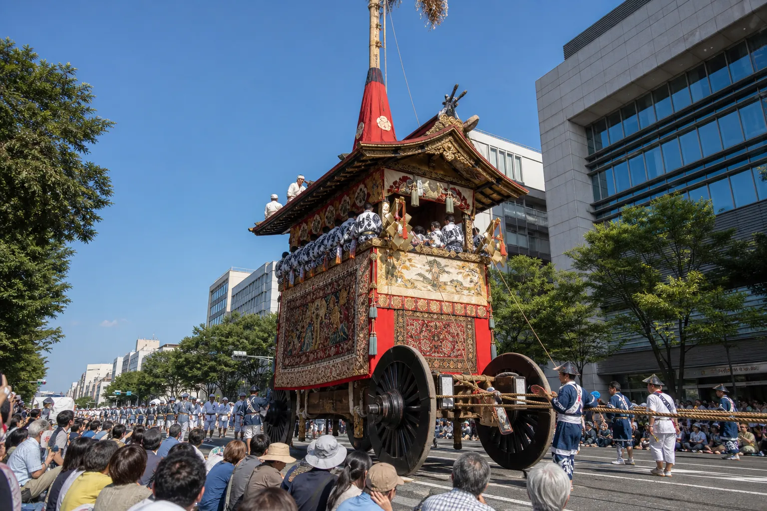 A tall decorated yamaboko float during the Gion Matsuri procession in Kyoto