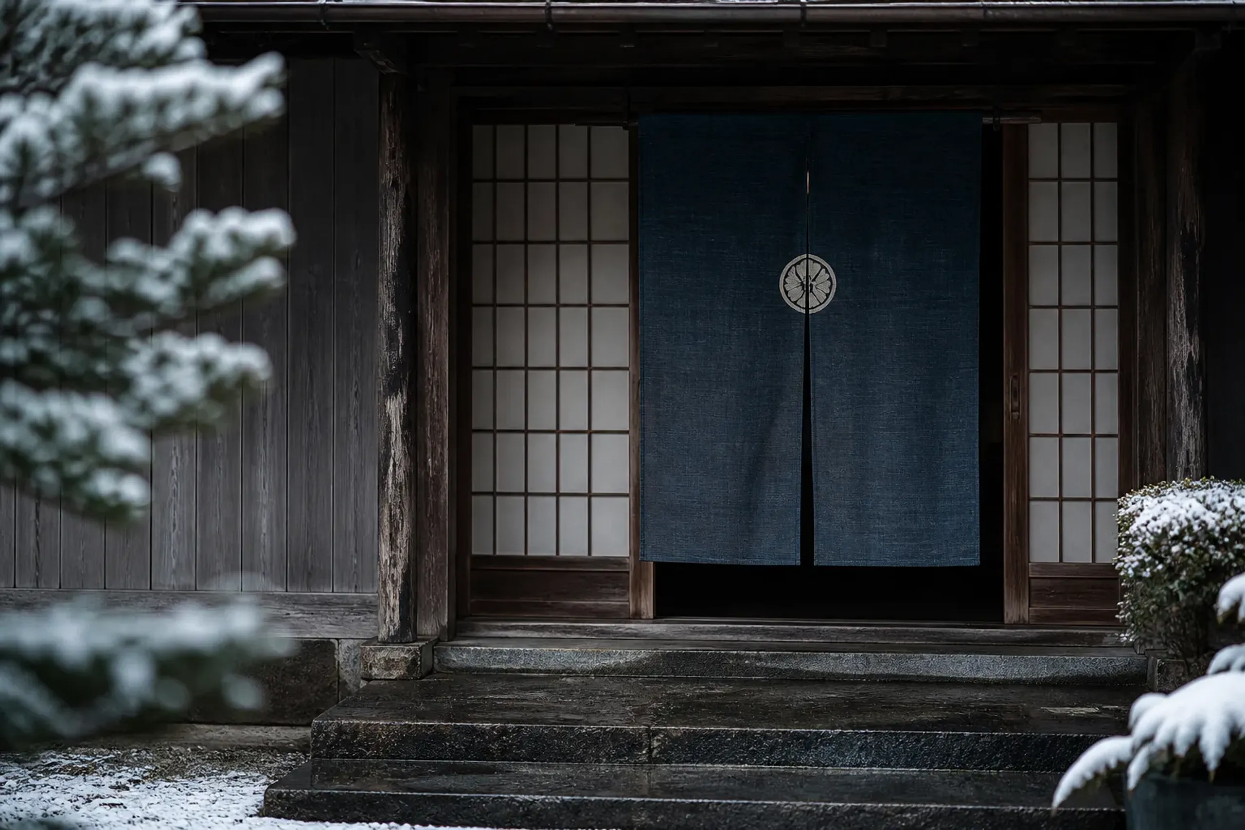 the quiet wooden entrance threshold of Tawaraya Ryokan at Fuyachō-dōri Anekōji-agaru in central Nakagyō, Kyoto, with sliding paper doors and a discreet noren