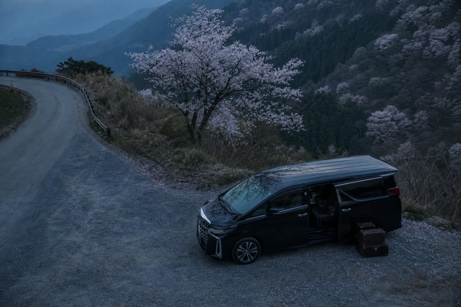 Luxury minivan and luggage at a quiet mountain roadside stop on the approach to Kamikochi