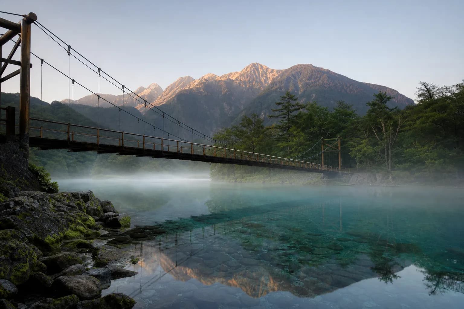 Kappabashi (Kappa Bridge) in Kamikochi at dawn with the Azusa River and mountains behind