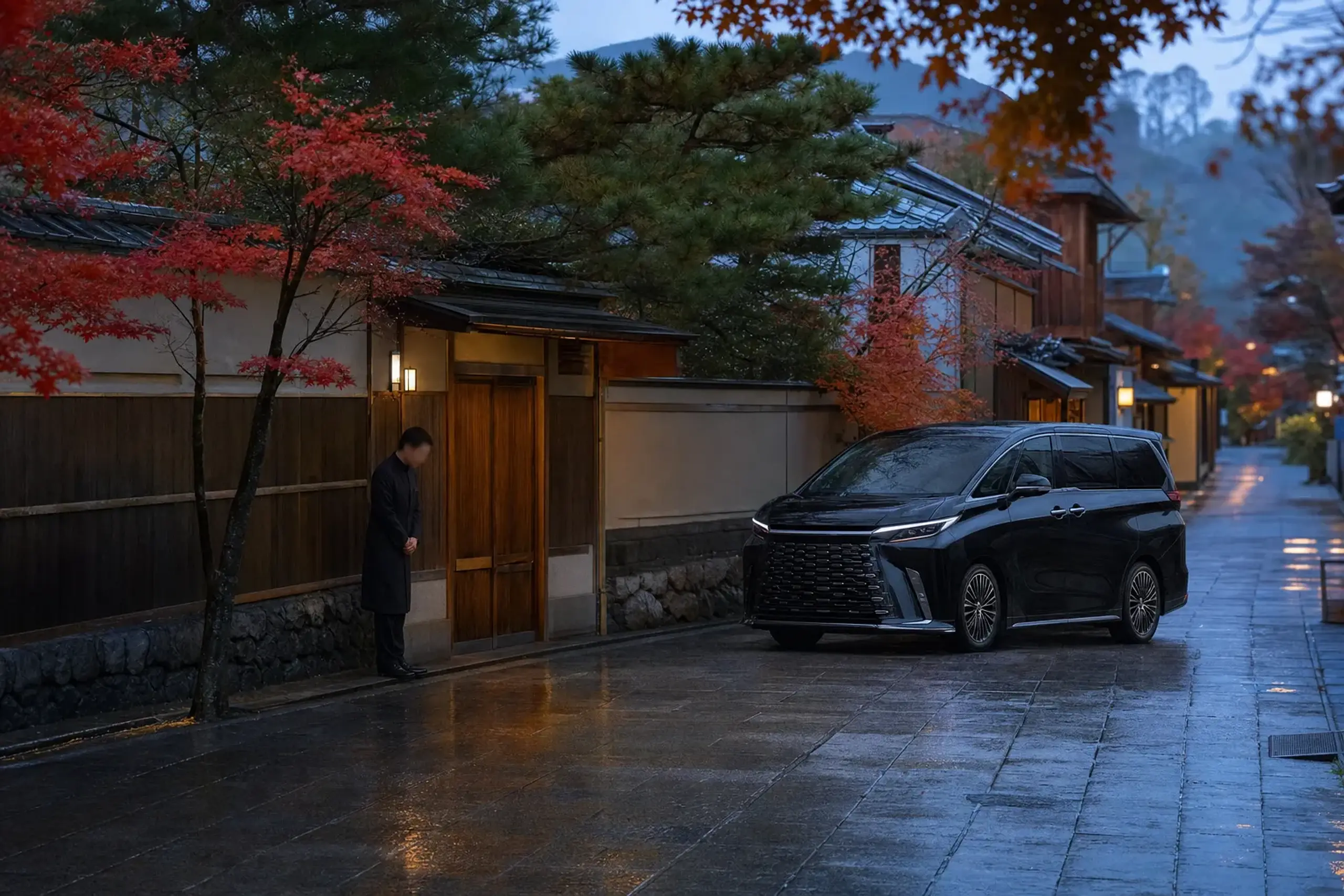 an unmarked black Lexus LM 500 pausing at a discreet side-lane delivery entrance of a Kyoto hotel, single staff member waiting by a plain unlabeled door
