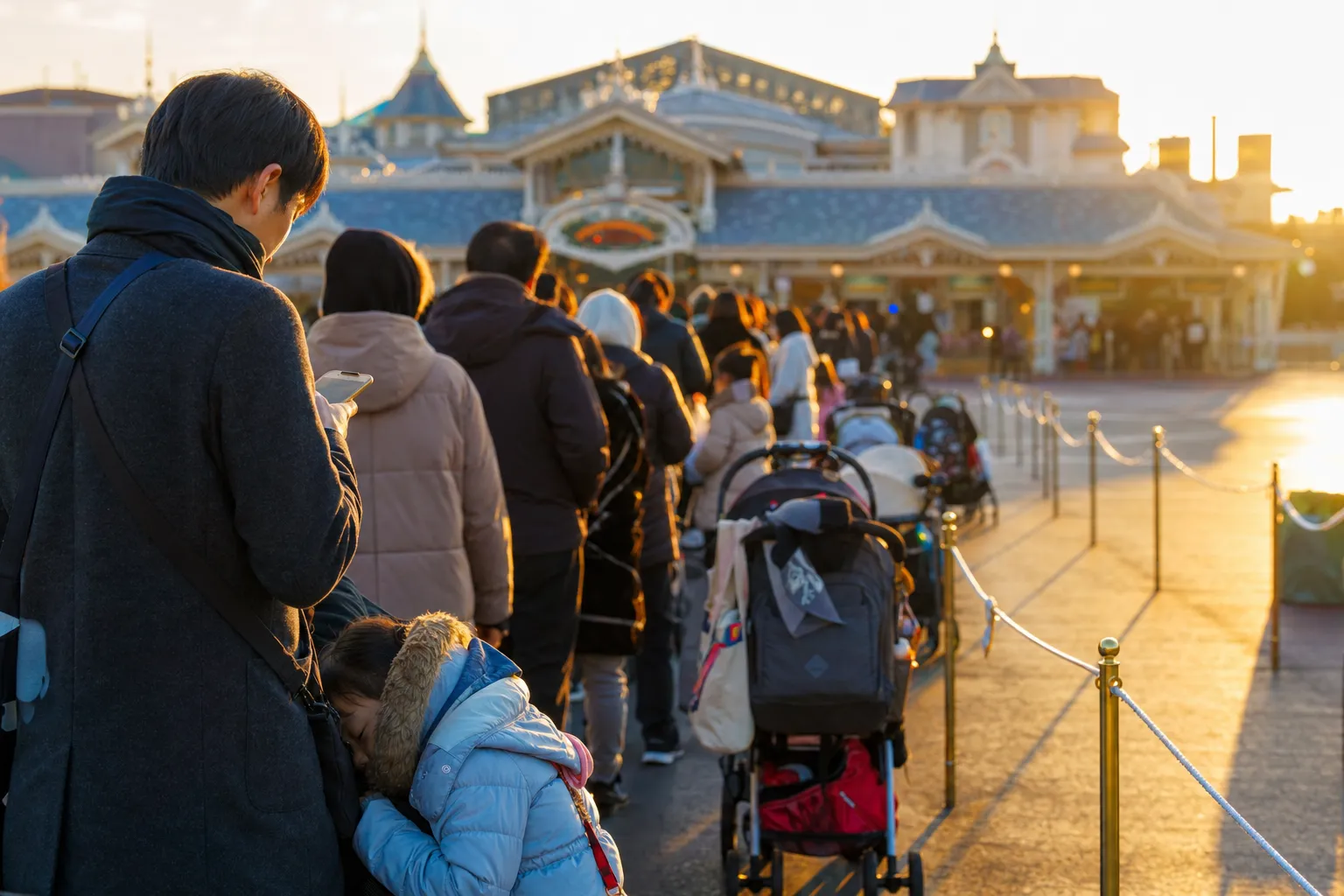 Families arriving early at Tokyo Disneyland entrance in the morning at Maihama