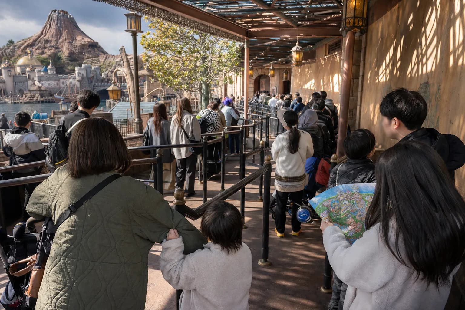 Parents and children waiting in a long queue at Tokyo Disney Resort