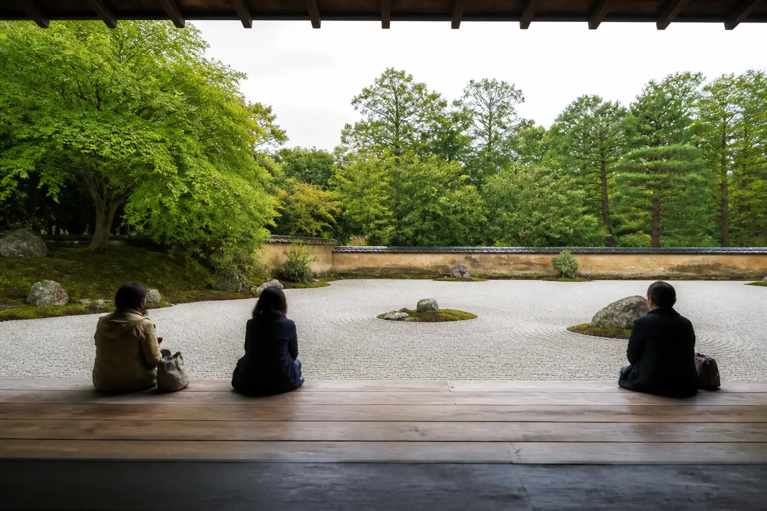 A tranquil public Japanese garden with a pond, maples and a wooden viewing veranda