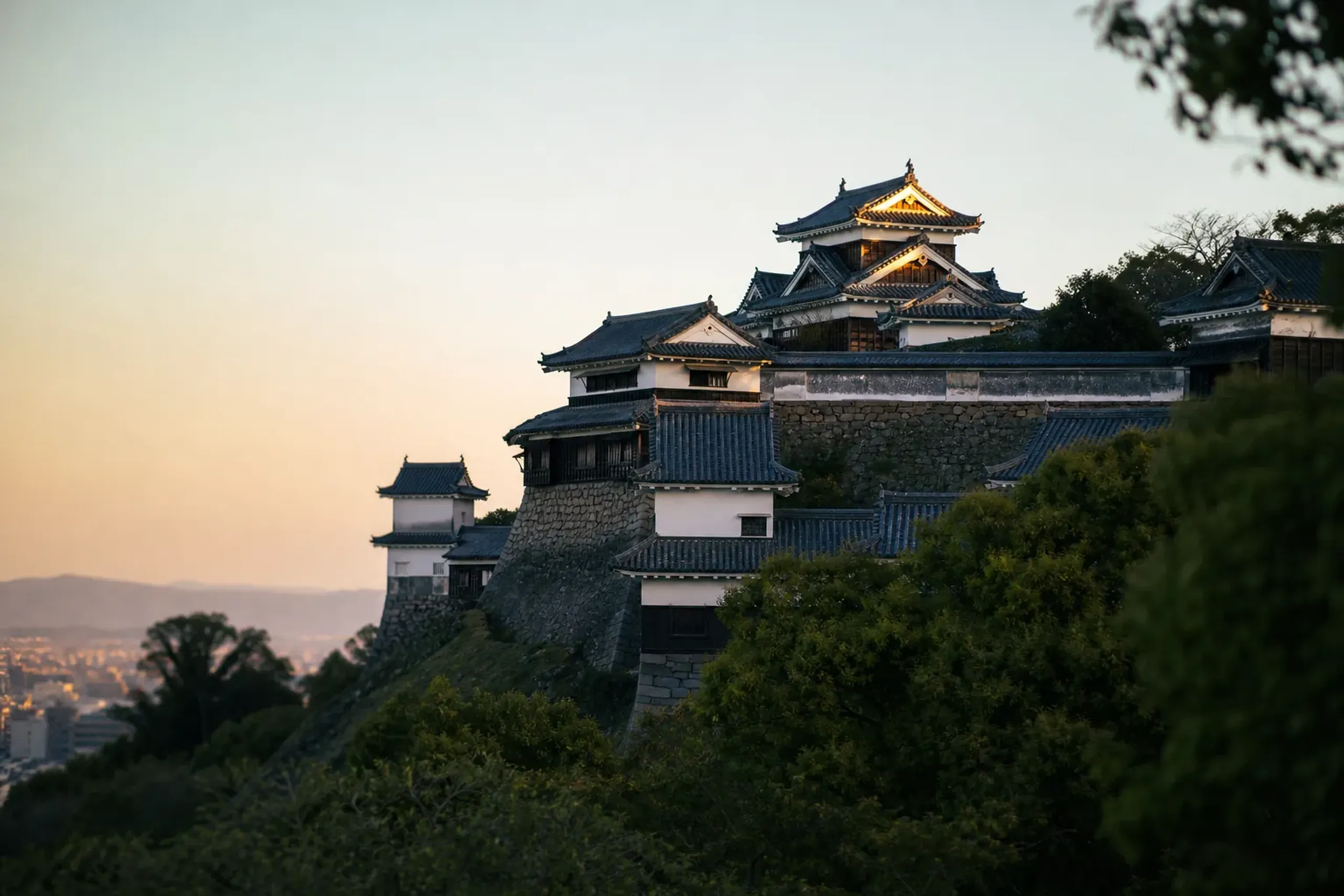 Matsuyama Castle's original keep standing on its hilltop above the city, one of the twelve surviving original castle keeps in Japan, reached by ropeway