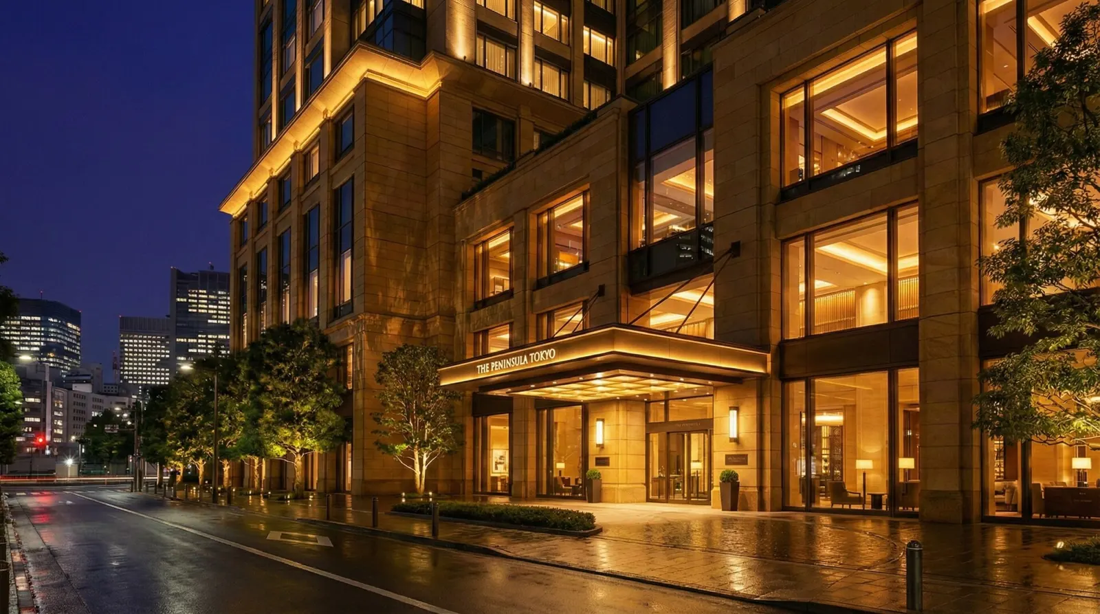 The Peninsula Tokyo hotel exterior glowing like a lantern at night in Marunouchi.