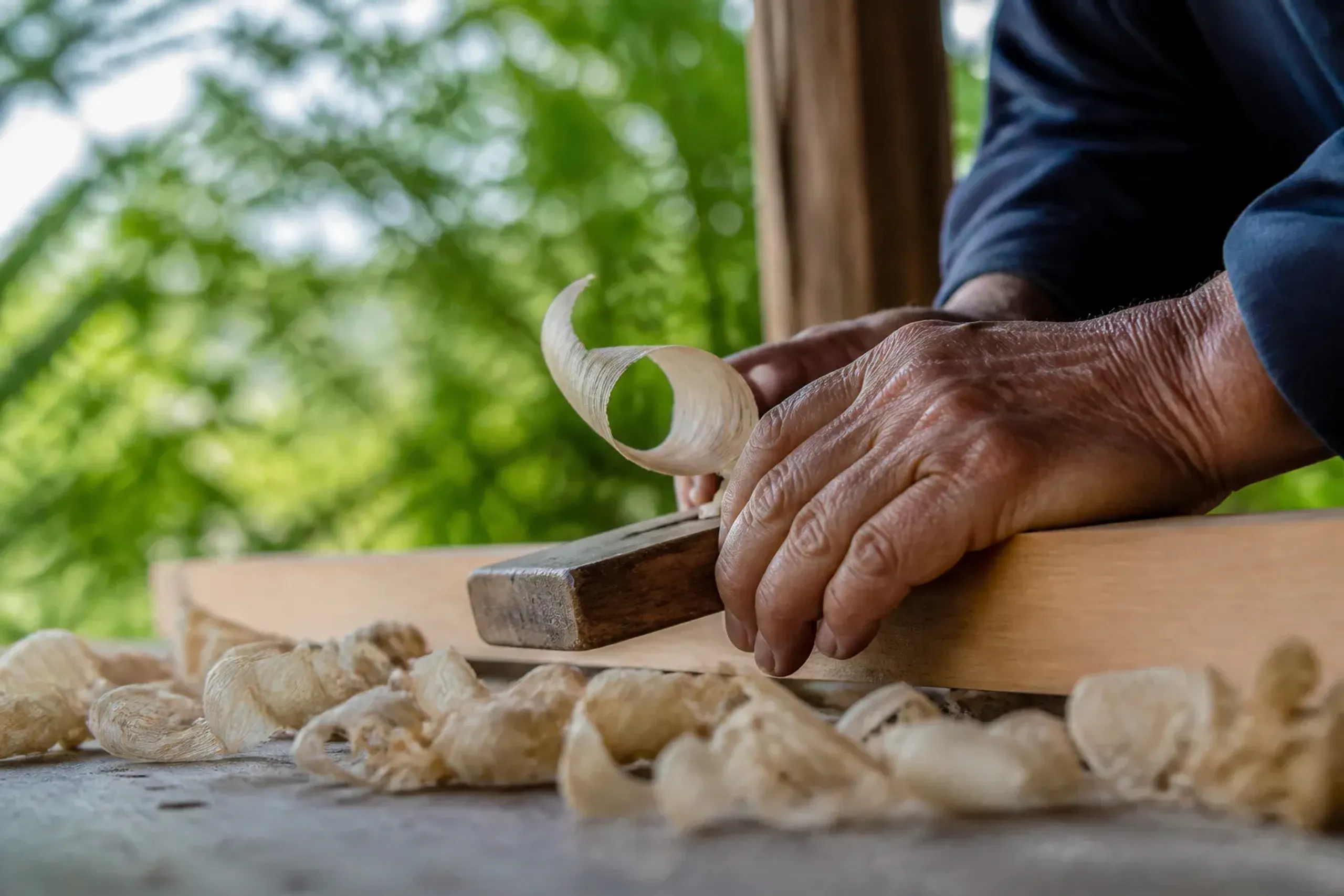 Artisan hands working with traditional tools in a Japanese workshop