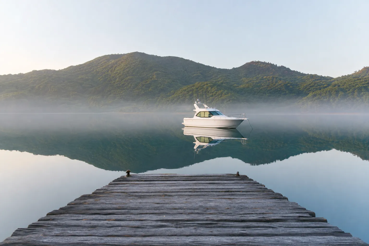 Small charter yacht moored at Uno Port in Okayama in calm morning light
