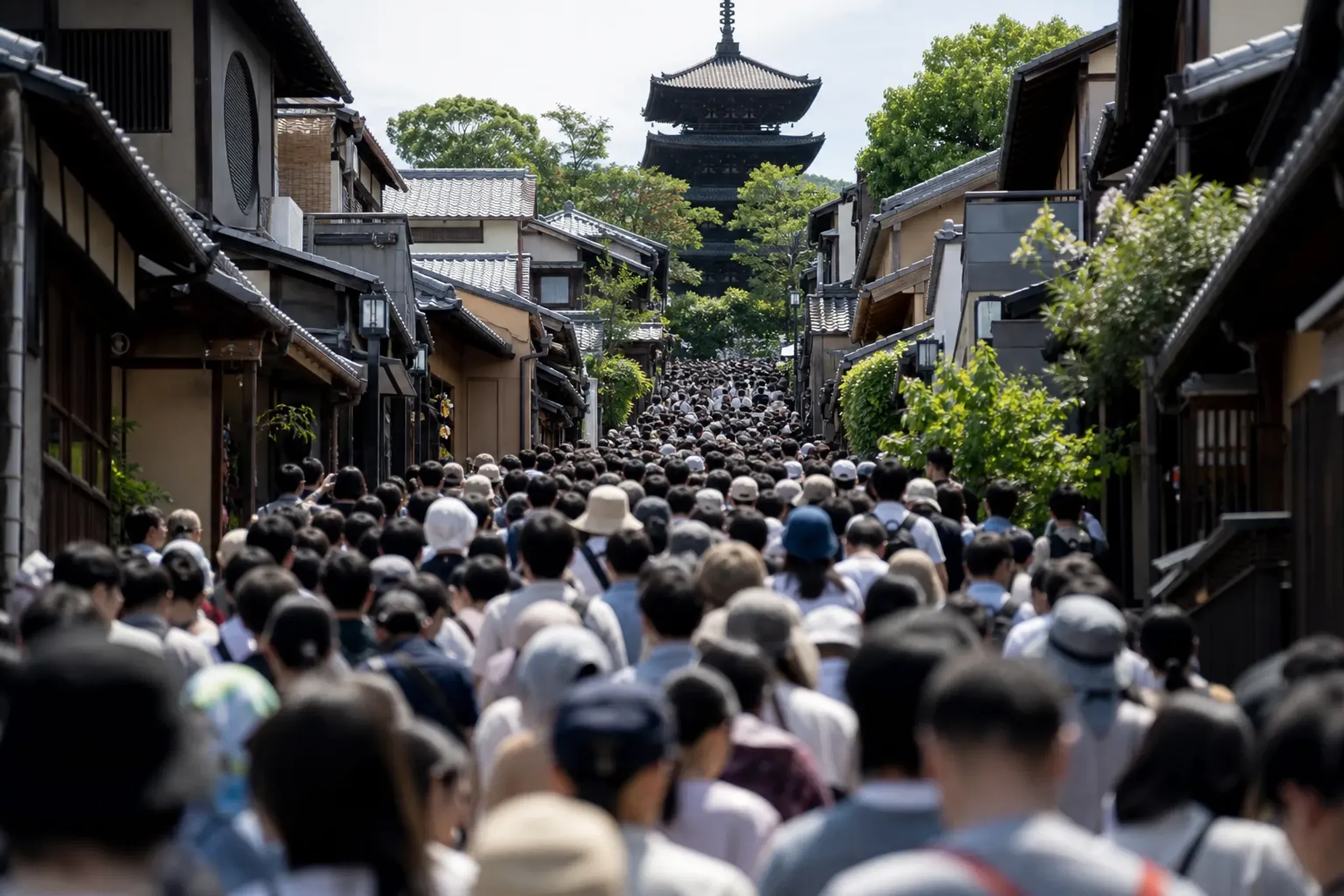 Crowded sloped approach to Kiyomizu-dera in Kyoto filled with visitors at midday