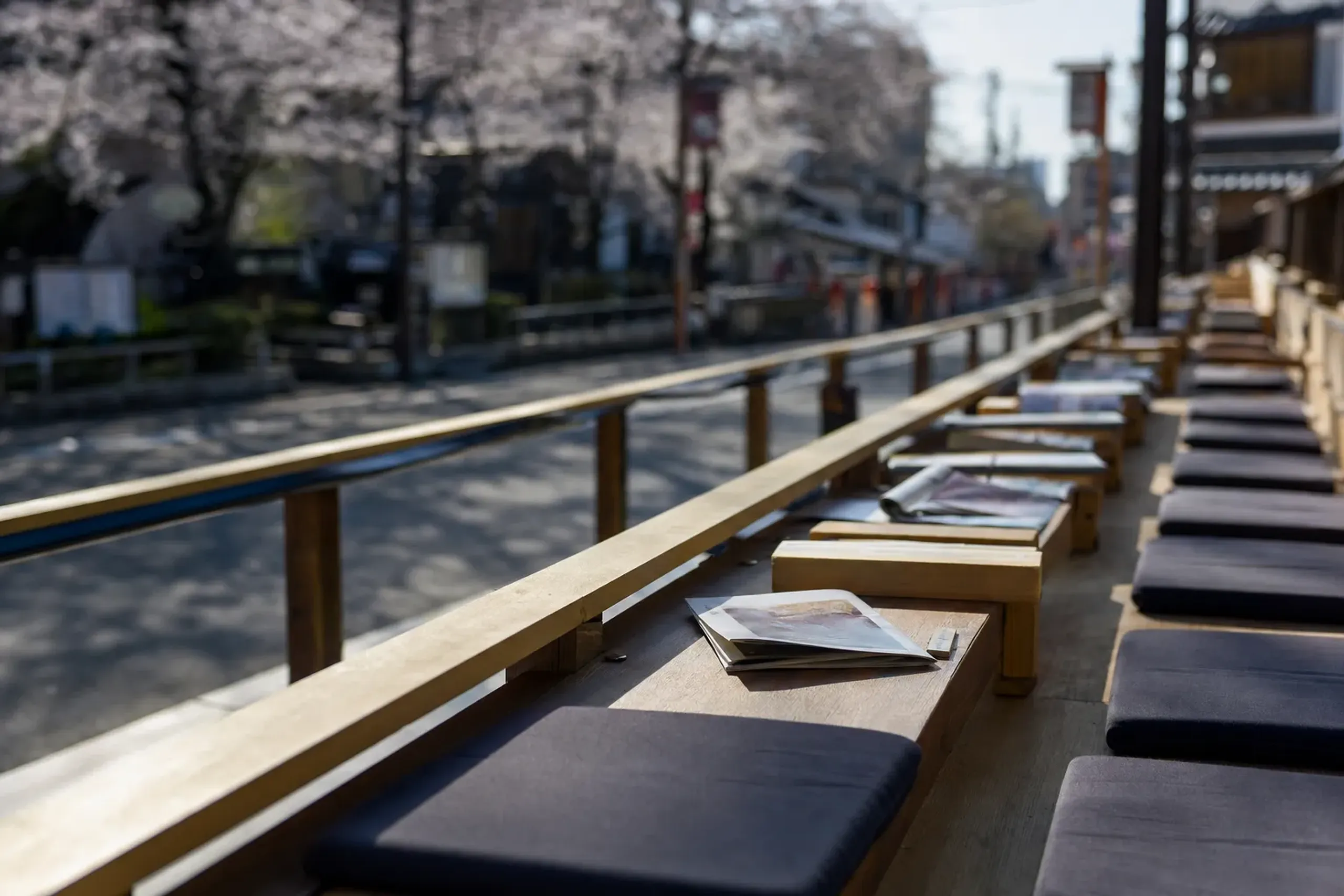 An empty reserved grandstand seating row facing Kanto Street before the evening balancing begins in Akita