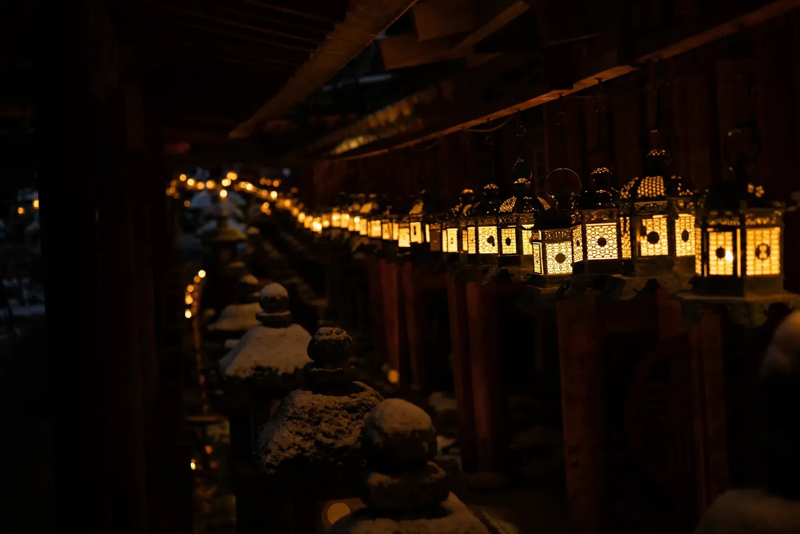 approximately 3,000 lit stone and bronze lanterns lining the corridors of Kasuga Taisha during the Chugen Mantoro