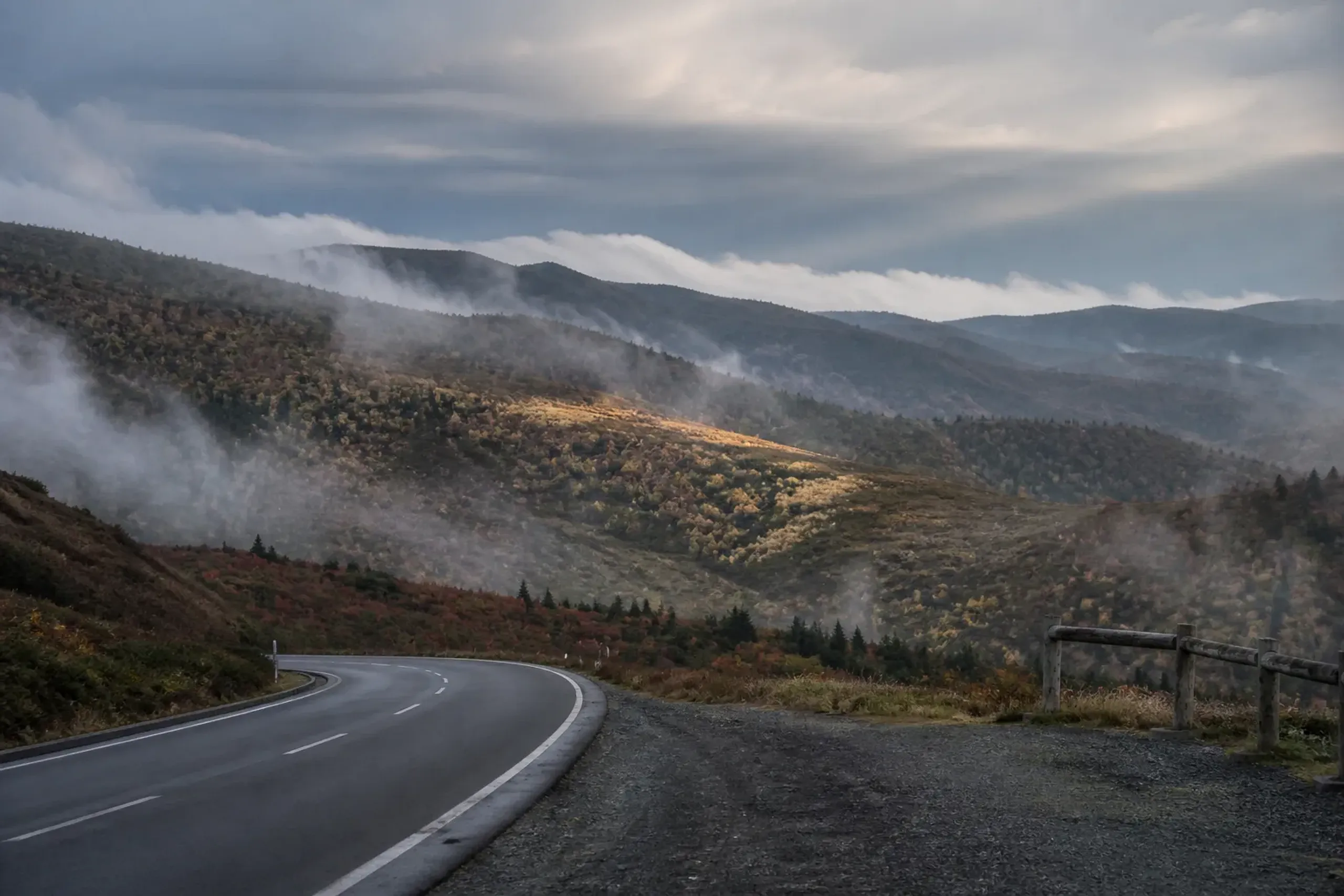 High-elevation autumn foliage in Hachimantai or the Zao range with foggy ridgelines