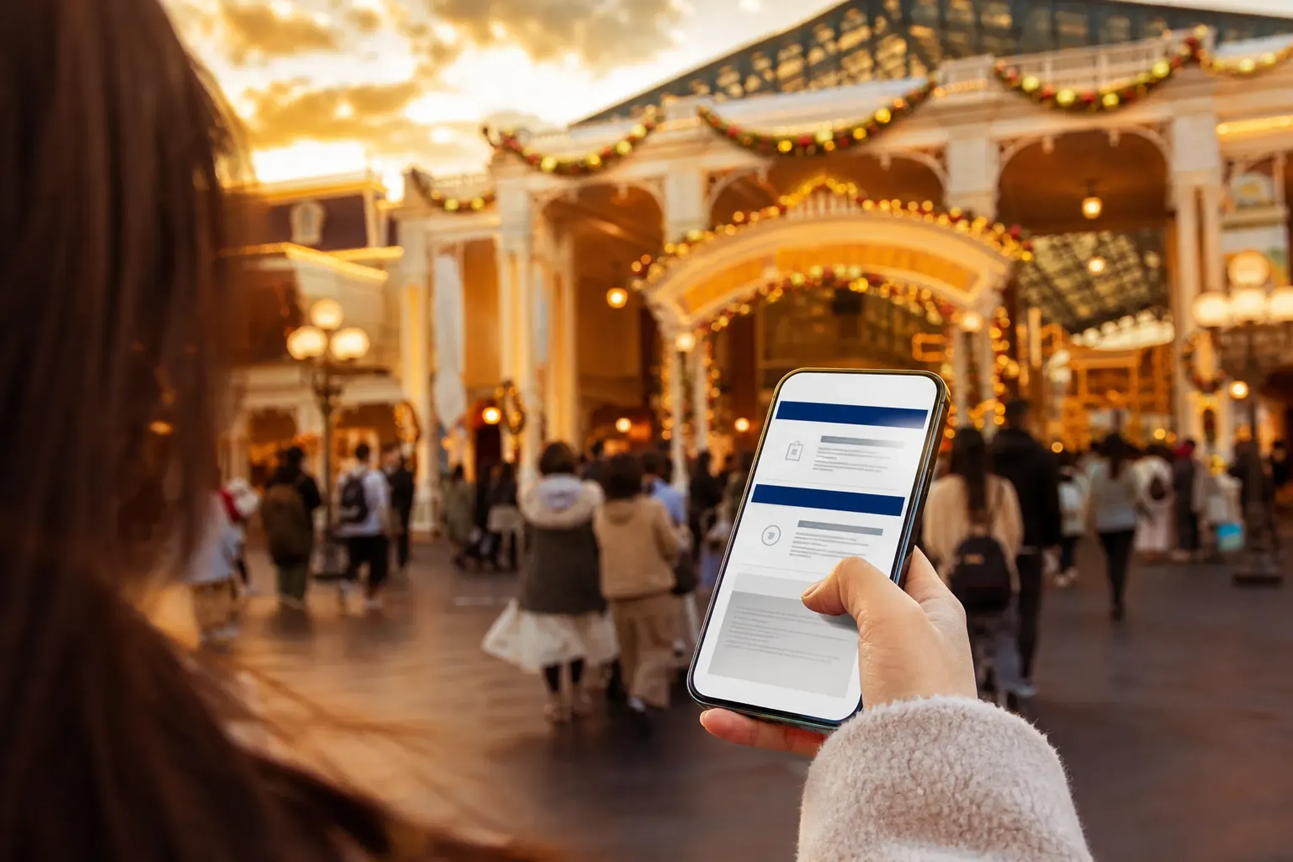 Traveler checking official Tokyo Disney Resort VIP tour rules on a smartphone before entering the park