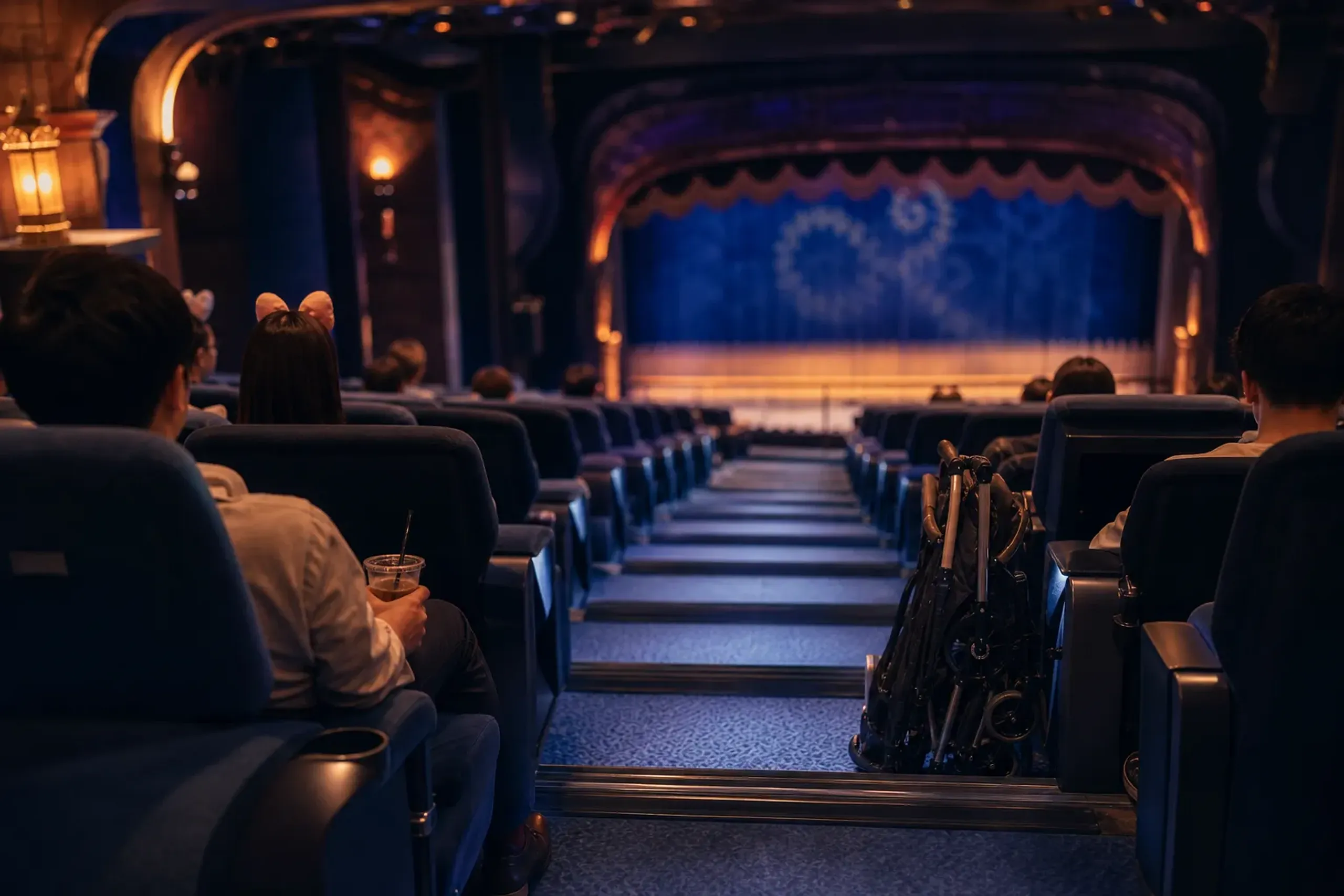 Guests seated inside an air-conditioned theater at Tokyo Disney Resort during summer