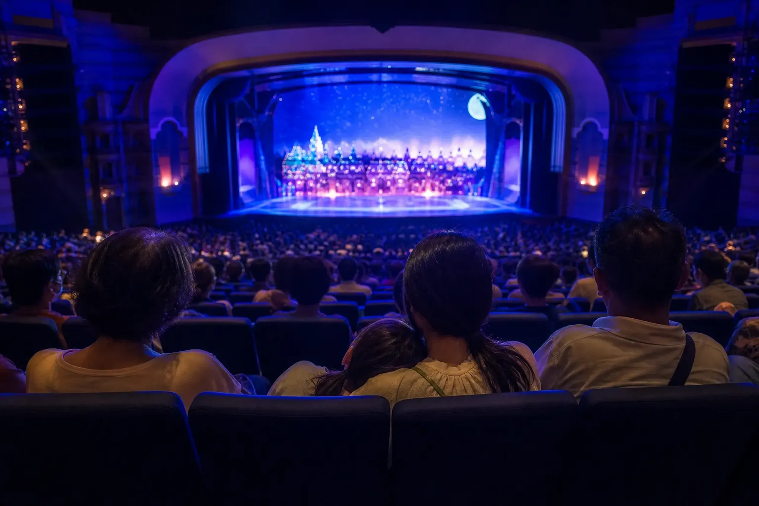 Guests seated inside an air-conditioned theater at Tokyo Disney Resort during summer