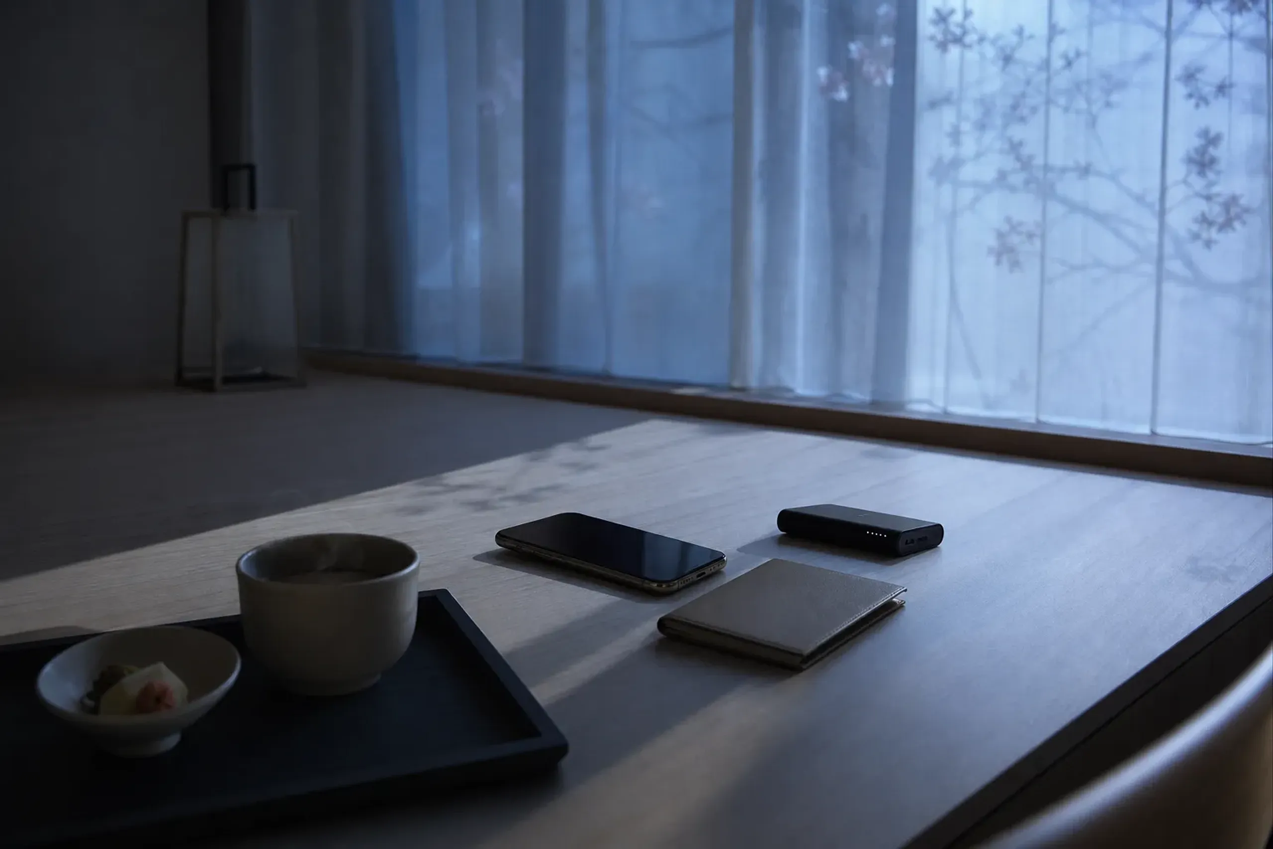 Phone, portable charger, and breakfast set up in a hotel room before a Tokyo Disney Resort day