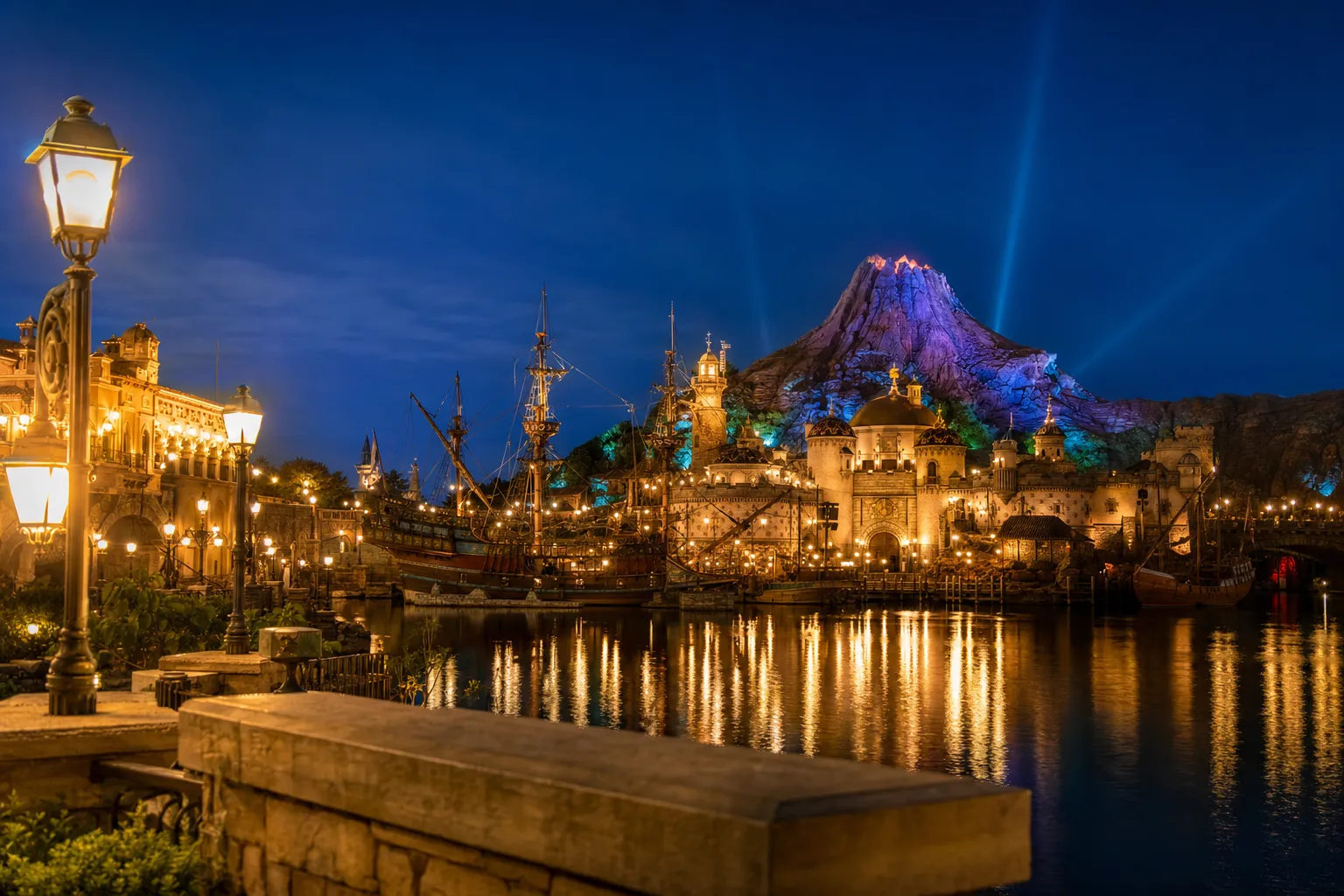 Tokyo DisneySea Mediterranean Harbor at night with lights reflecting on the water