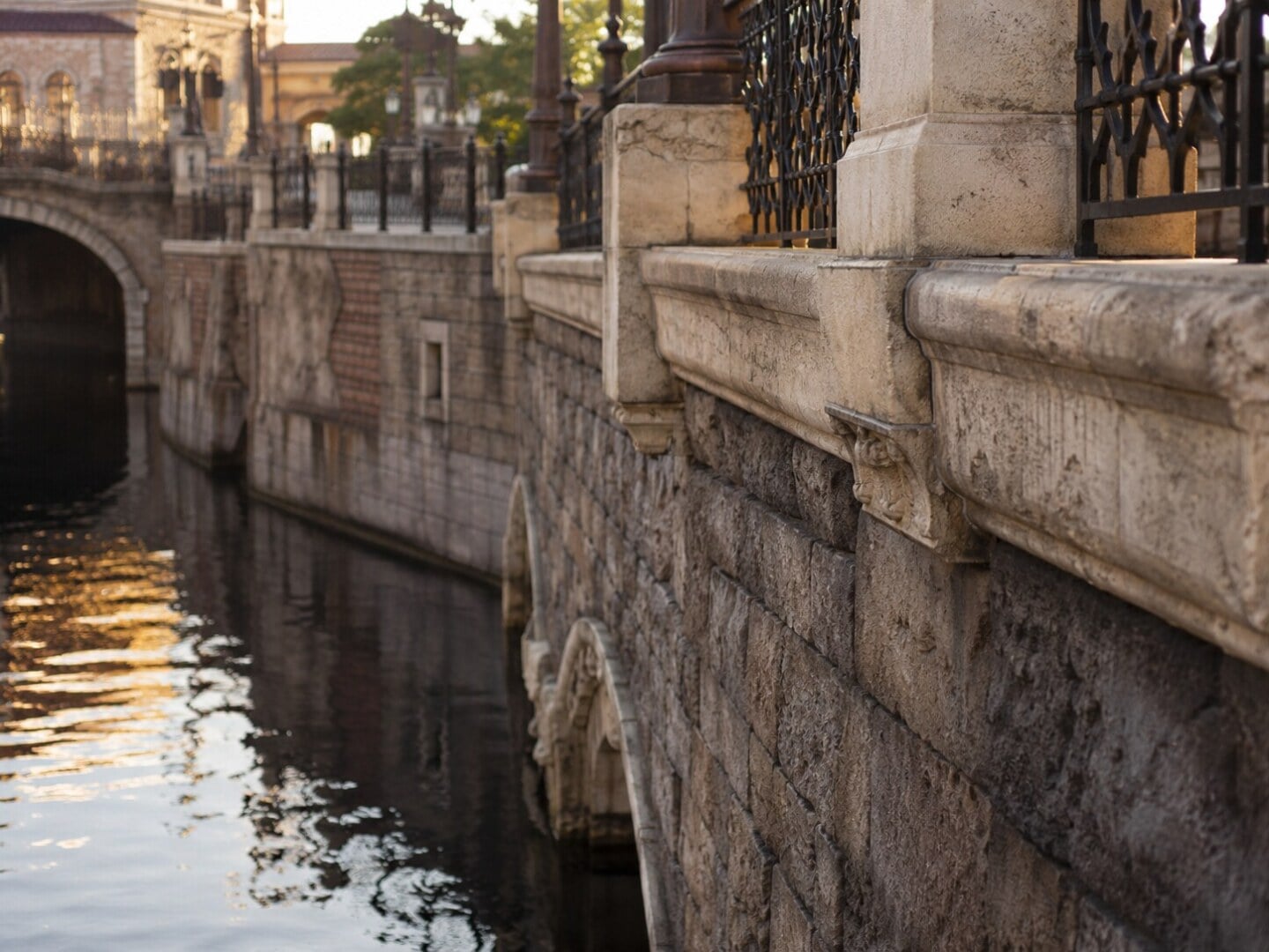 Intricate stonework and a peaceful canal capturing the wabi-sabi and craftsmanship found throughout Tokyo DisneySea.
