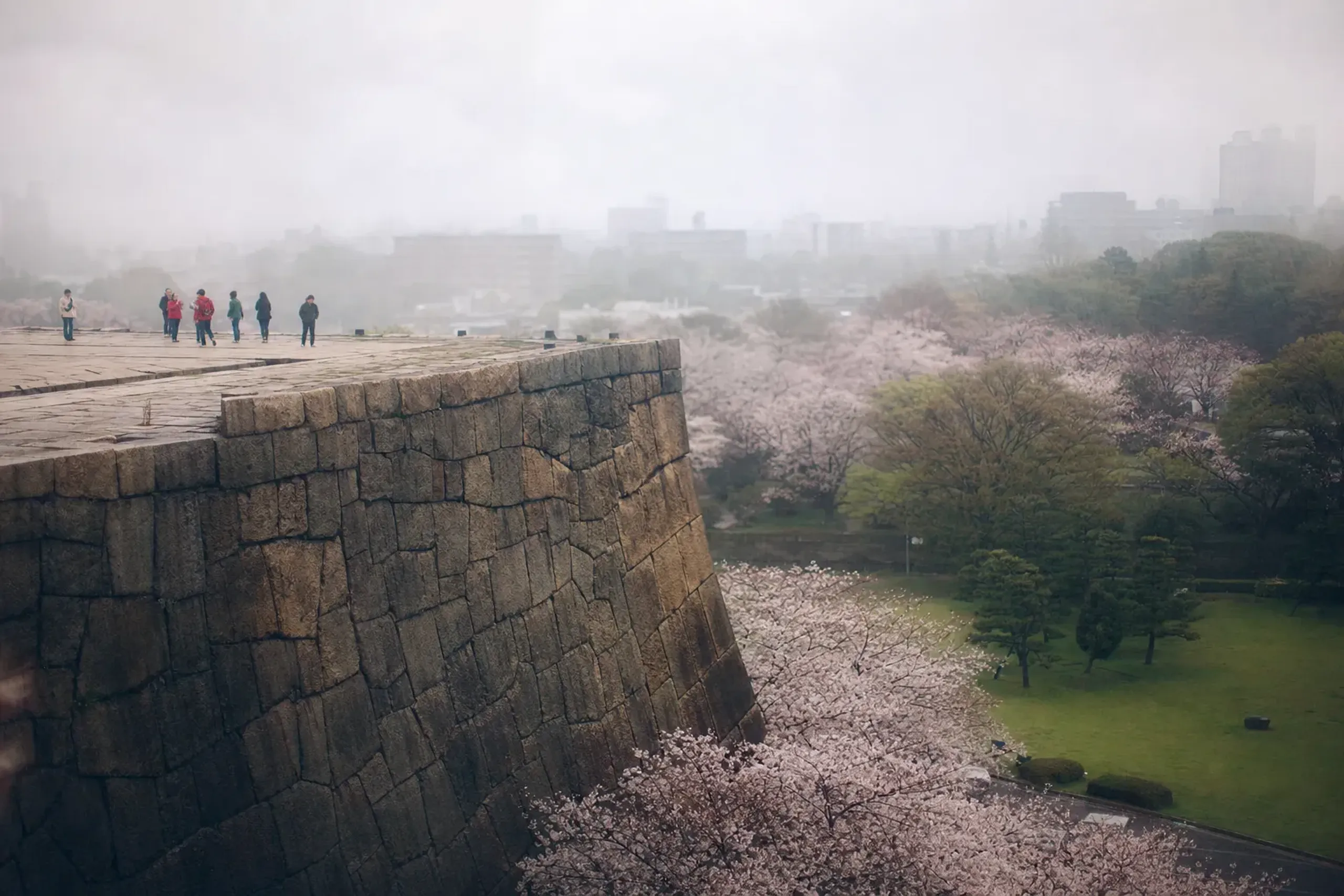 Stone keep base of Edo Castle in the Imperial Palace East Gardens, Tokyo, with visitors on top