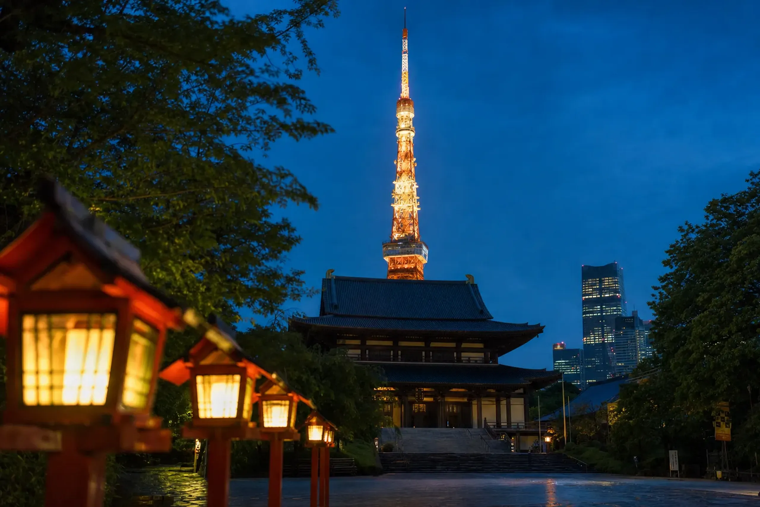 Zōjō-ji temple halls silhouetted against the illuminated Tokyo Tower at dusk
