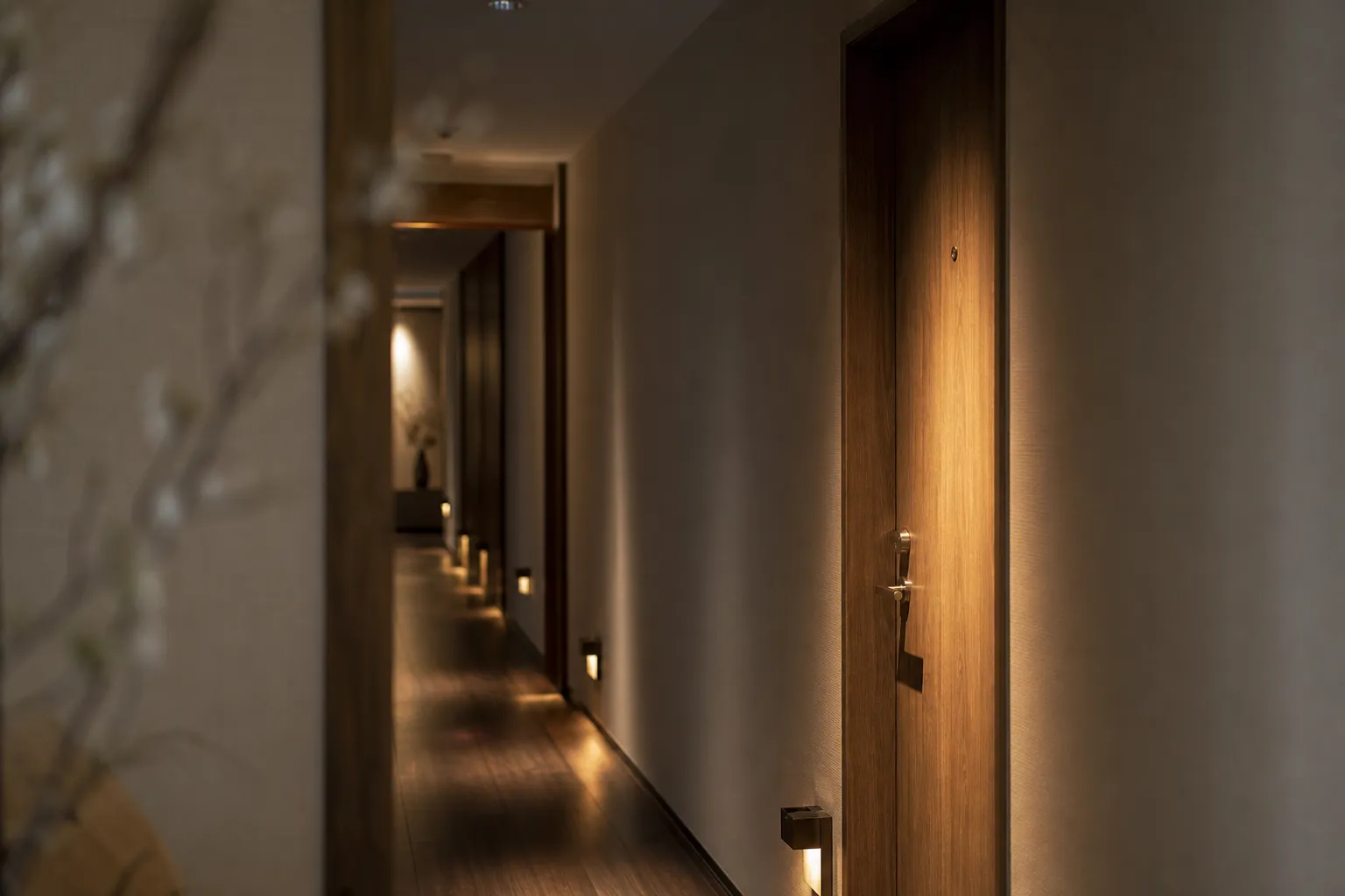 Quiet hotel corridor with warm lighting and minimal foot traffic, emphasizing privacy