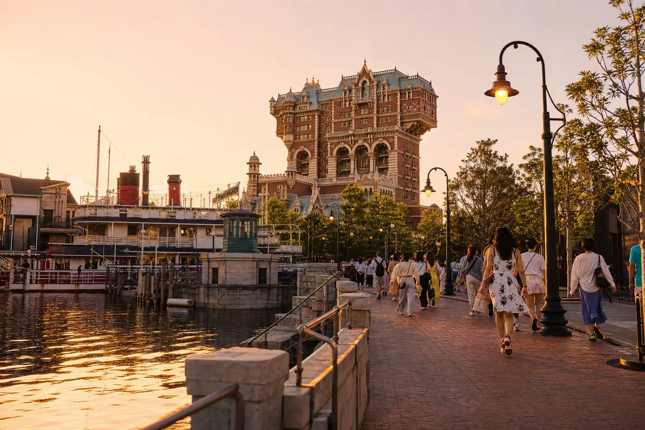 American Waterfront at Tokyo DisneySea during golden hour with guests strolling and Tower of Terror in the background