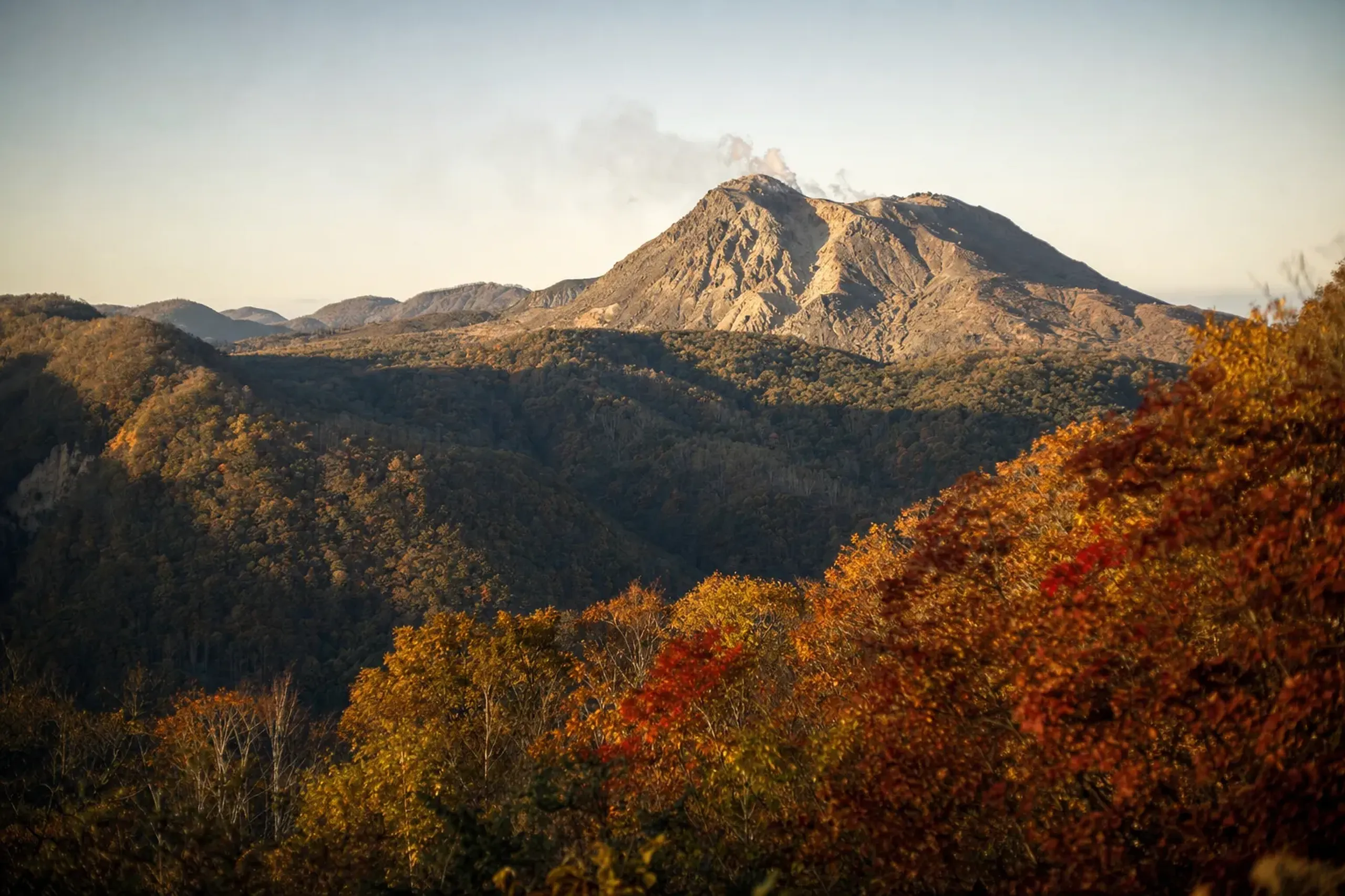 The solidified lava dome of Heisei Shinzan rising to 1,483 metres, viewed across the valley from Nita Pass