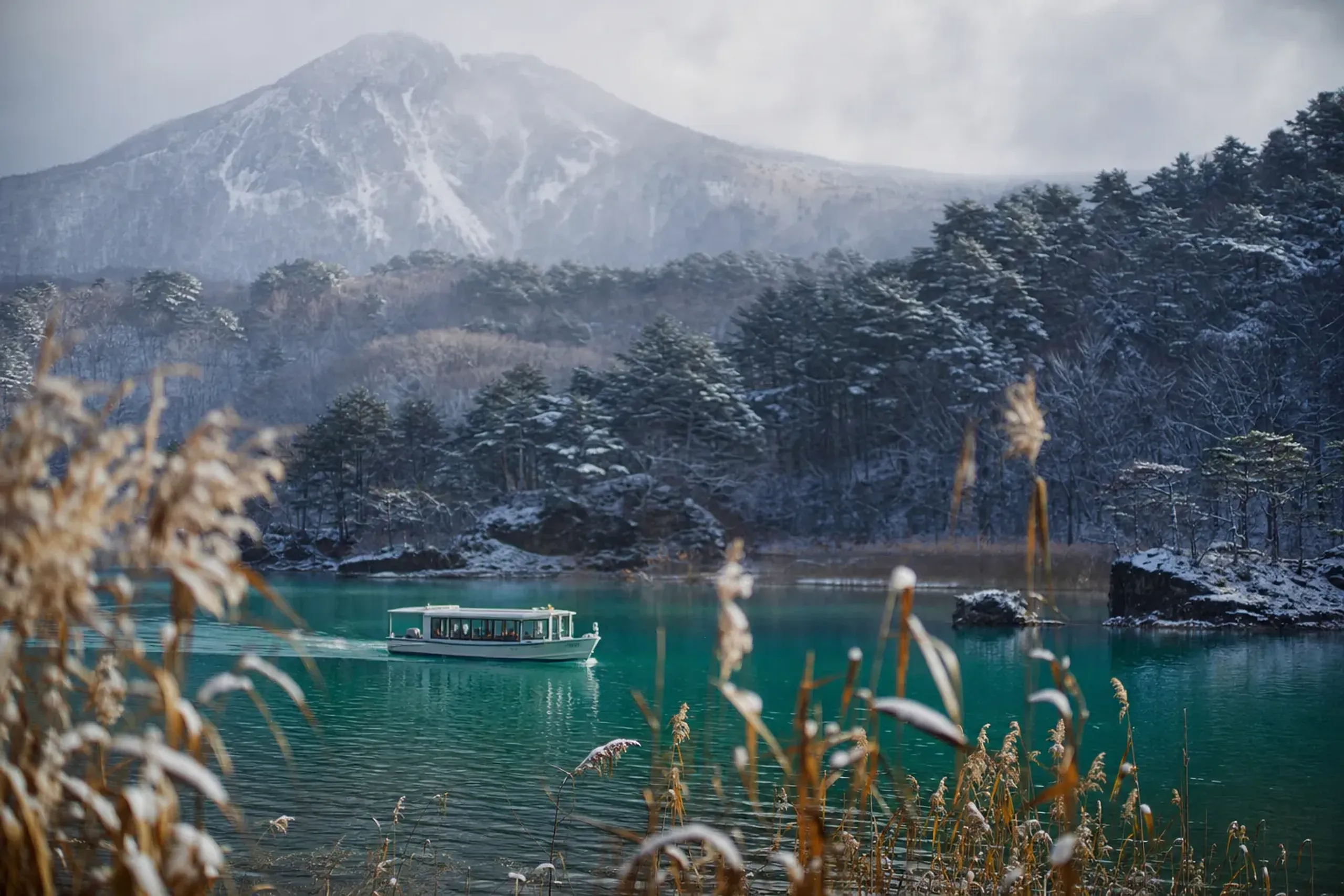 A sightseeing boat run by Urabandai Lake Resort crosses the