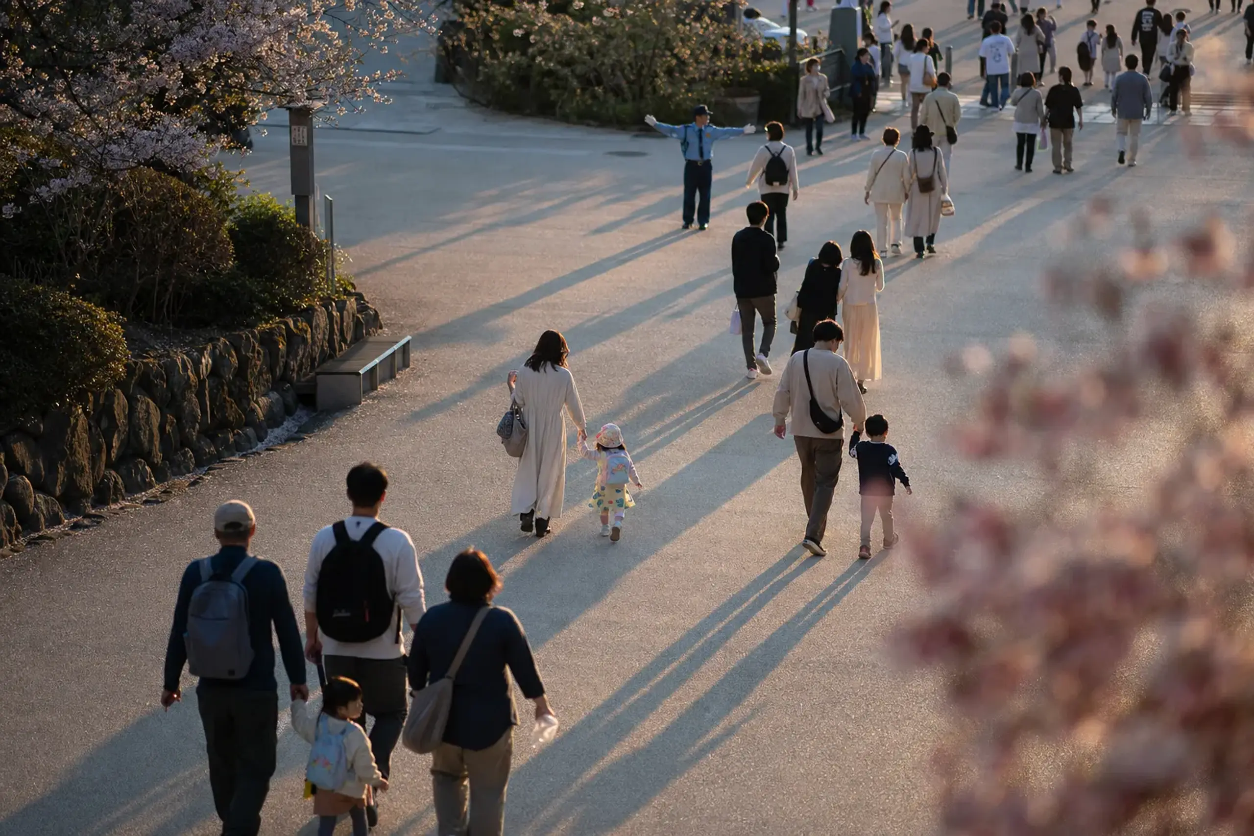 Families walking toward the exit at Universal Studios Japan in late afternoon before 18:00