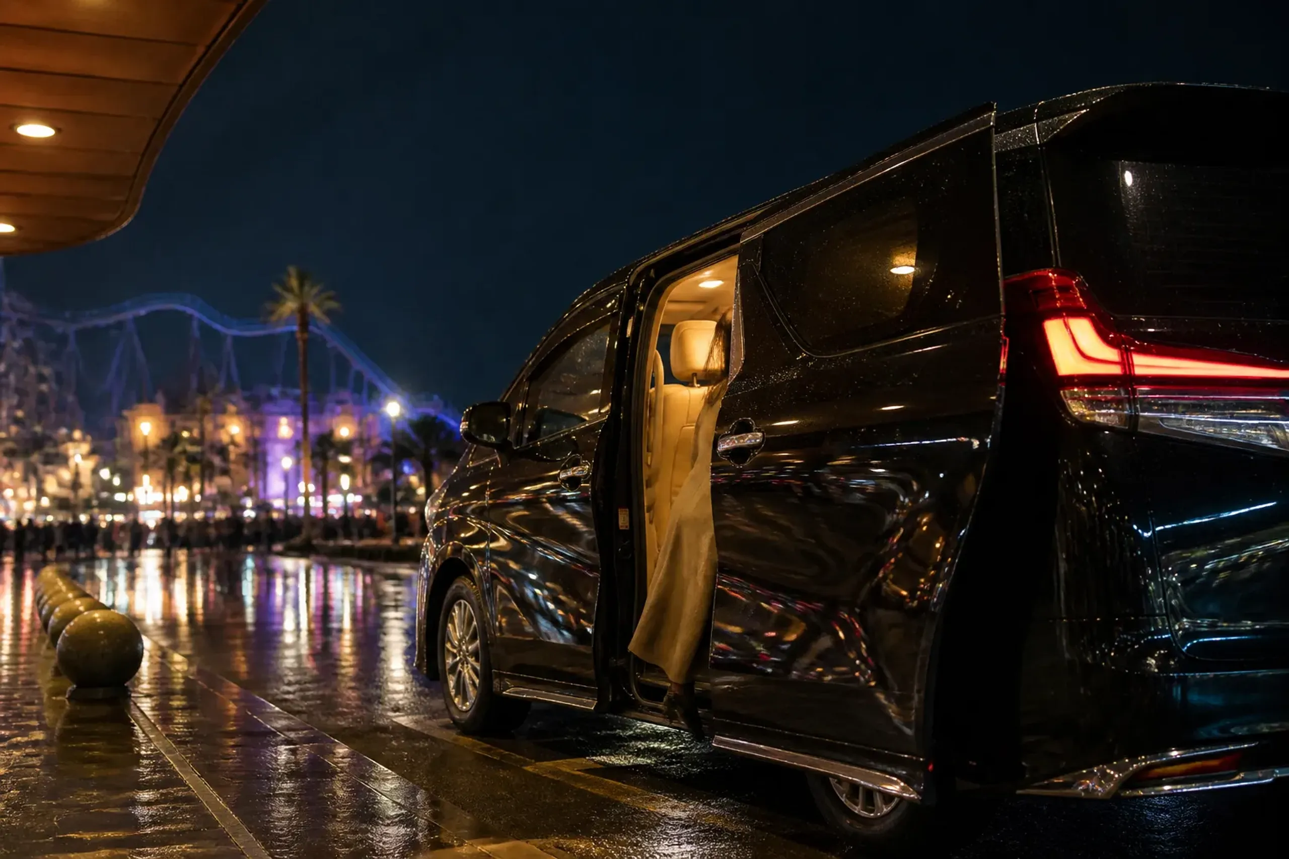 Private chauffeured minivan pickup at night after a theme park visit