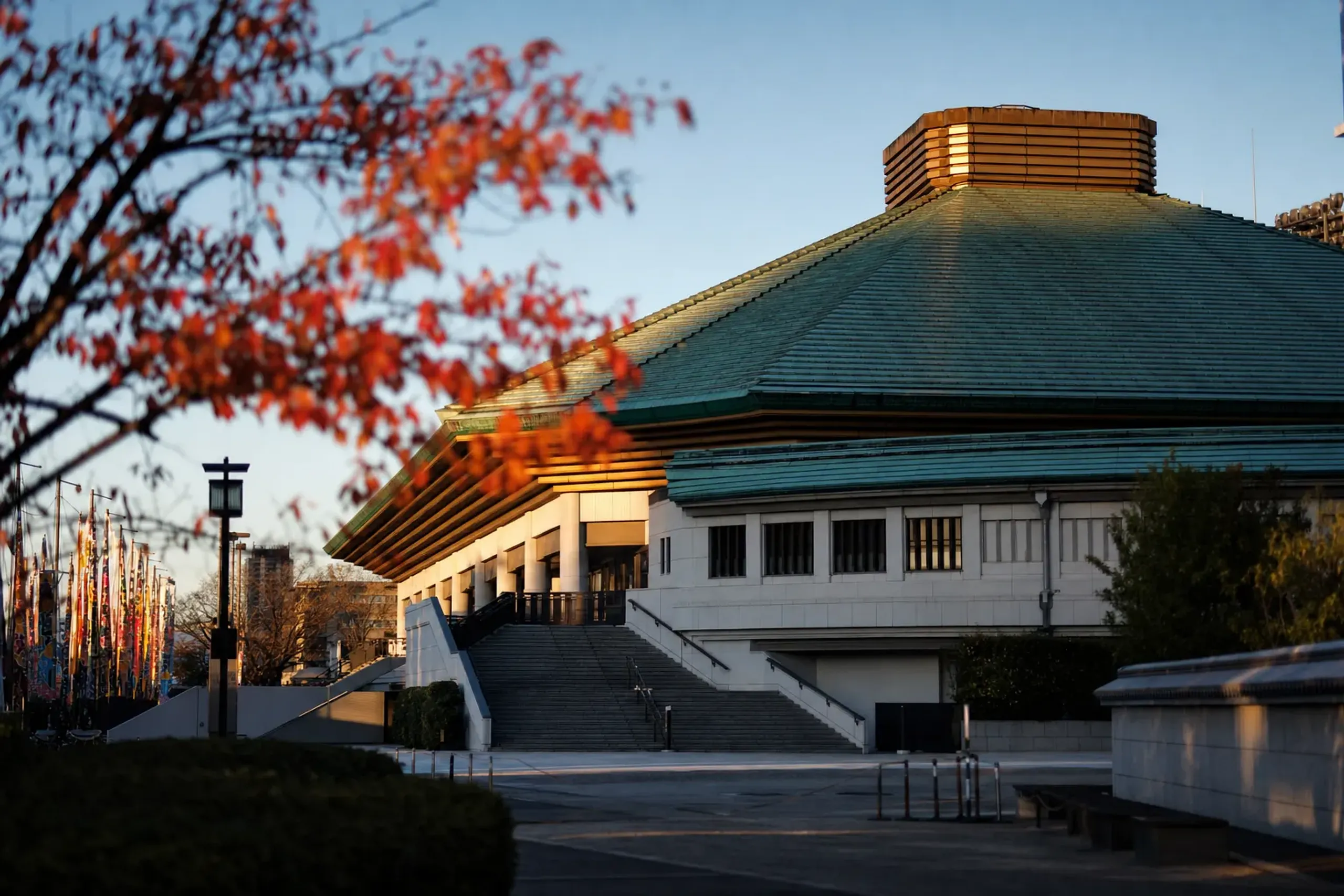 The exterior facade of the Ryogoku Kokugikan sumo arena with its distinctive green tiered roof