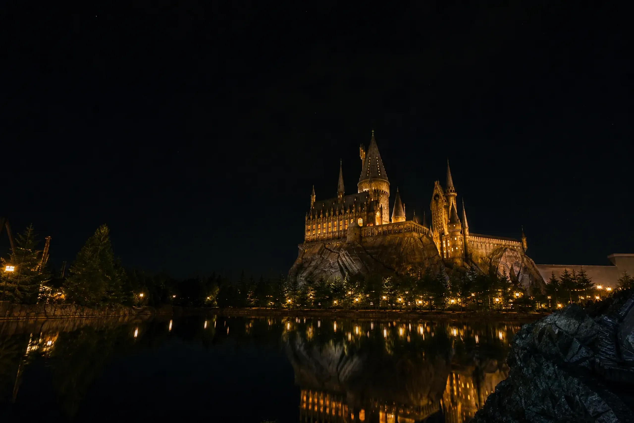Hogwarts Castle lit up at night in The Wizarding World of Harry Potter at Universal Studios Japan