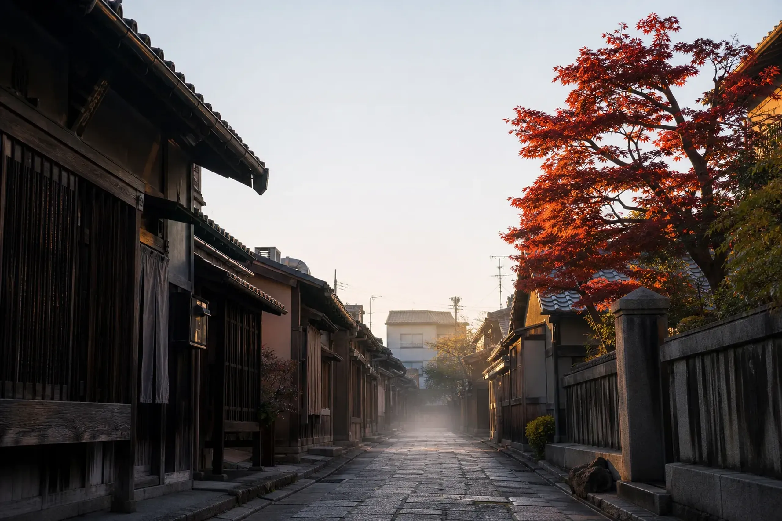 a narrow residential lane in Kyoto's Nishijin textile district at dawn, lined with weathered wooden machiya townhouses and traditional weaving workshops, empty and silent under low morning light