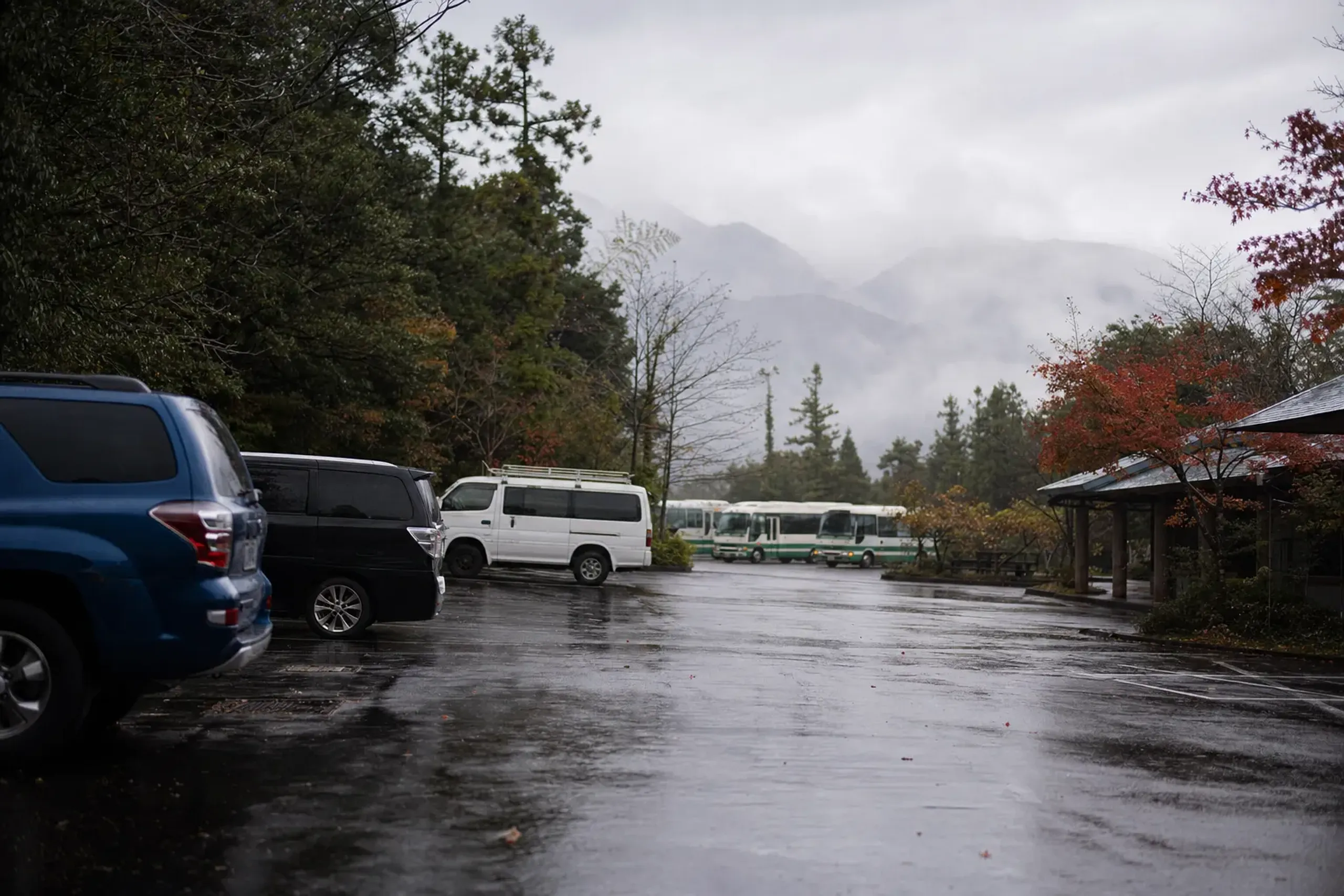 Vehicles parked at Yakusugi Museum area where hikers transfer to the Arakawa climbing bus