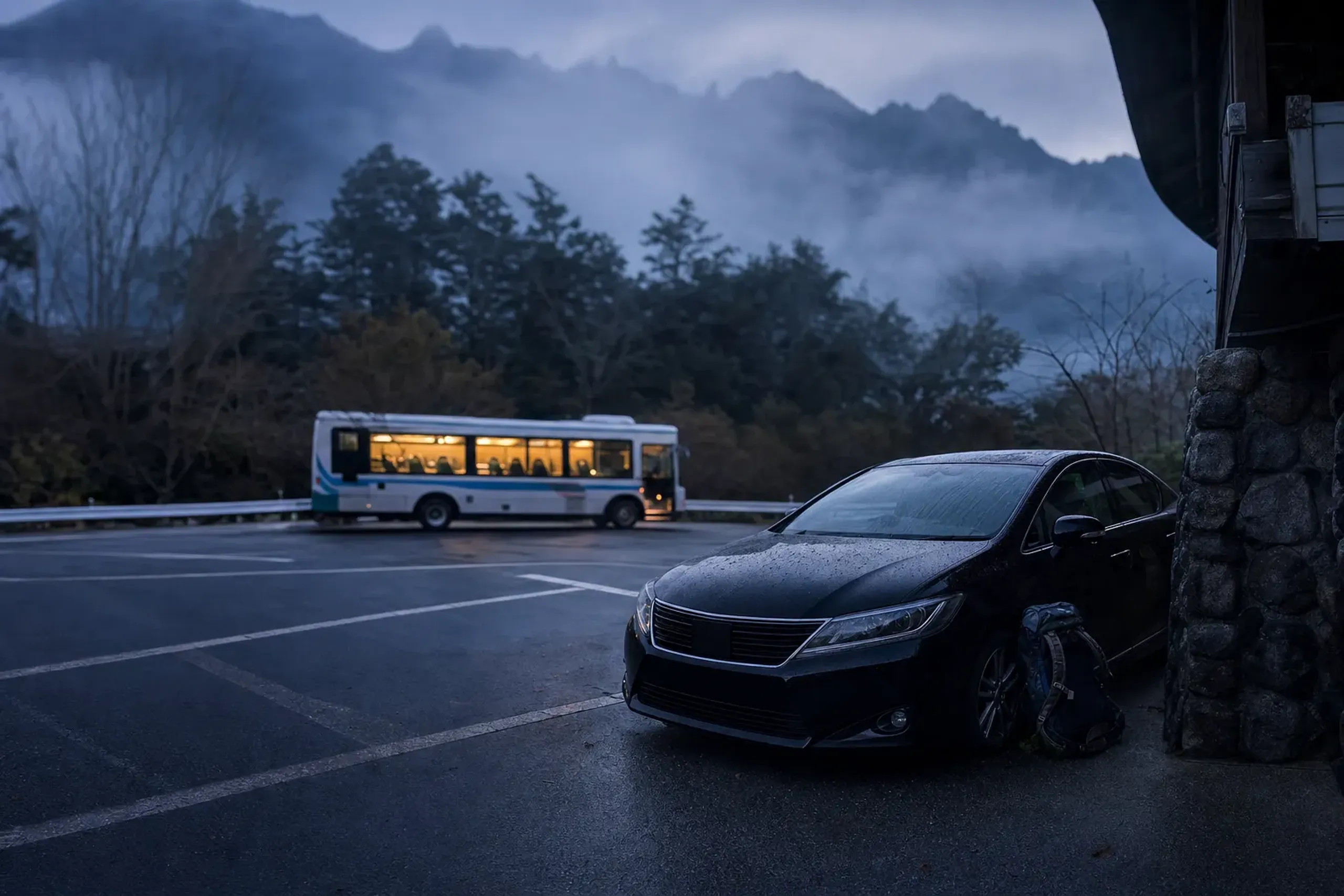 the Yakusugi Museum car park at dawn where private vehicles are parked before transferring to the Arakawa climbing bus