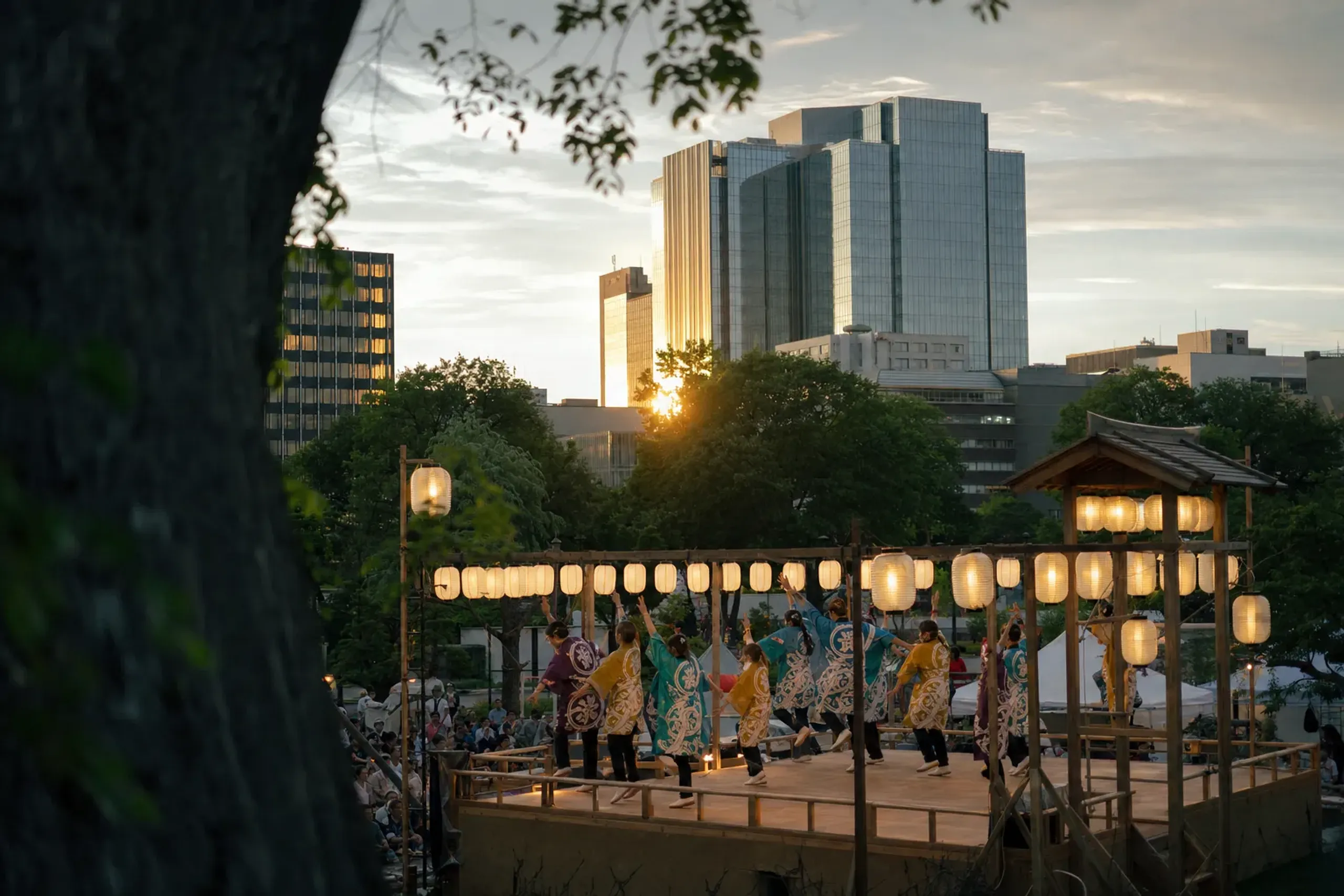 The Nishi-hachi-chōme stage area near central Sapporo hotels with the festival stage set against surrounding city buildings