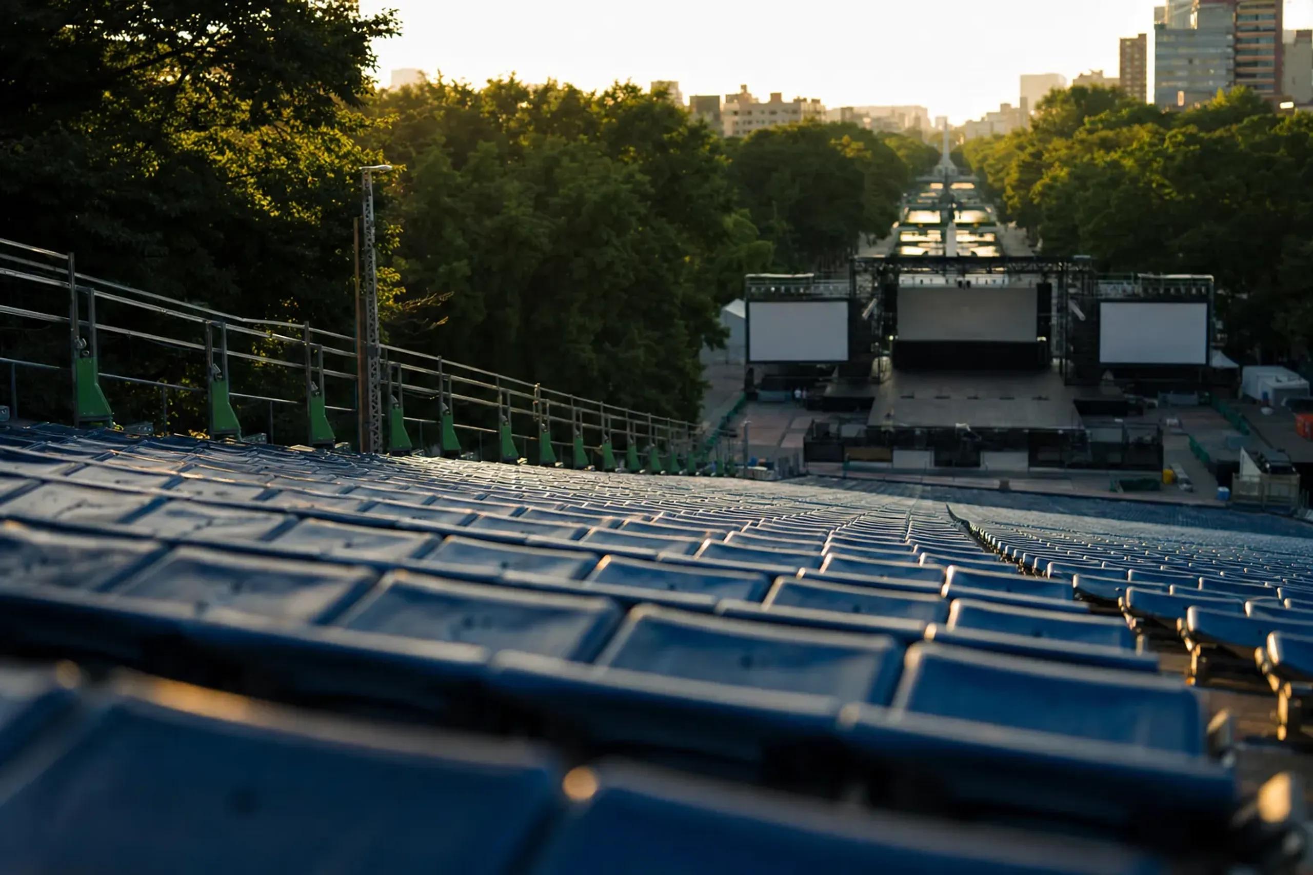 Rows of tiered spectator seating facing a fixed YOSAKOI Soran stage along Ōdori Park in Sapporo
