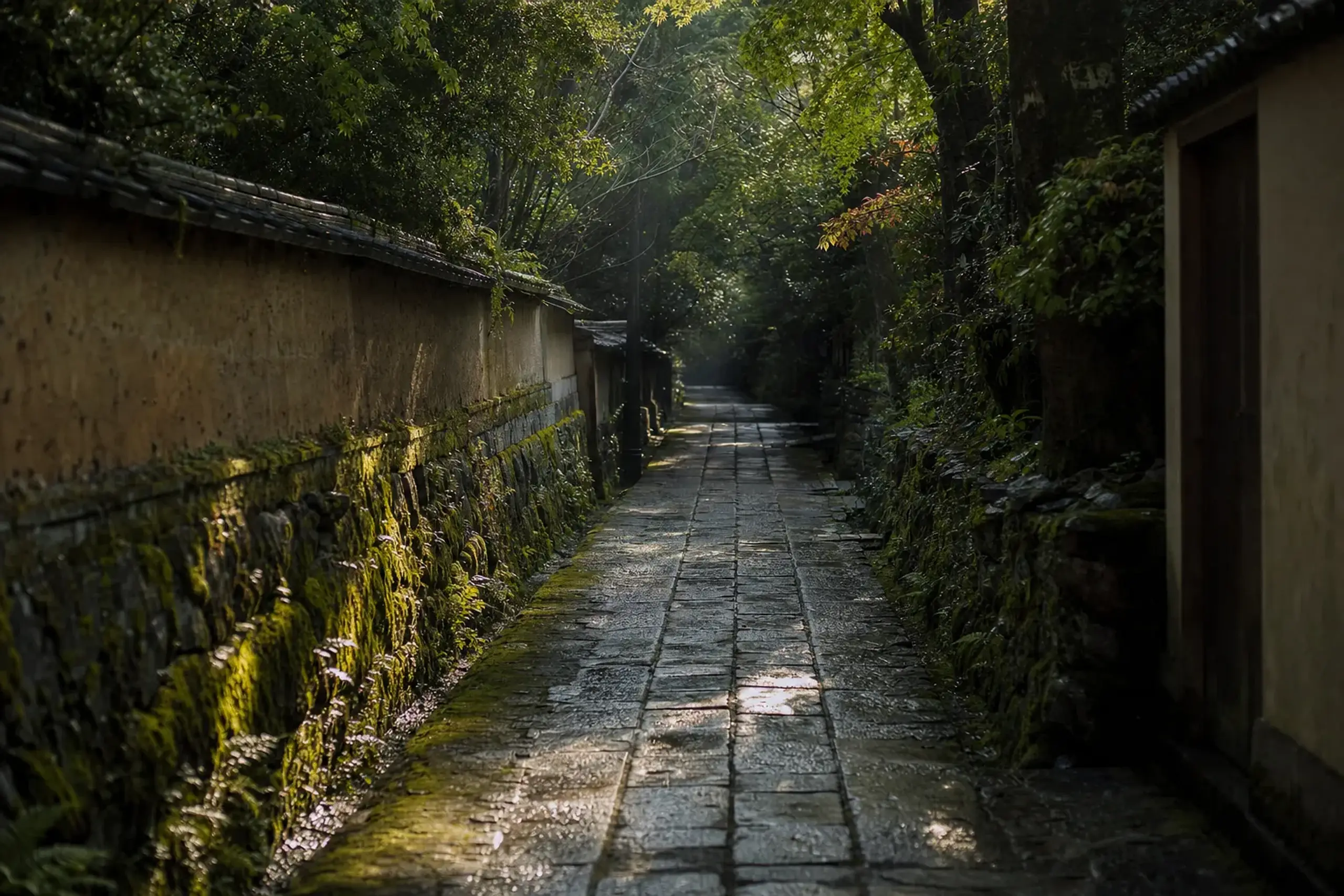 A quiet moss-covered side lane in Yufuin at early morning, empty of tourists, with soft light filtering through trees