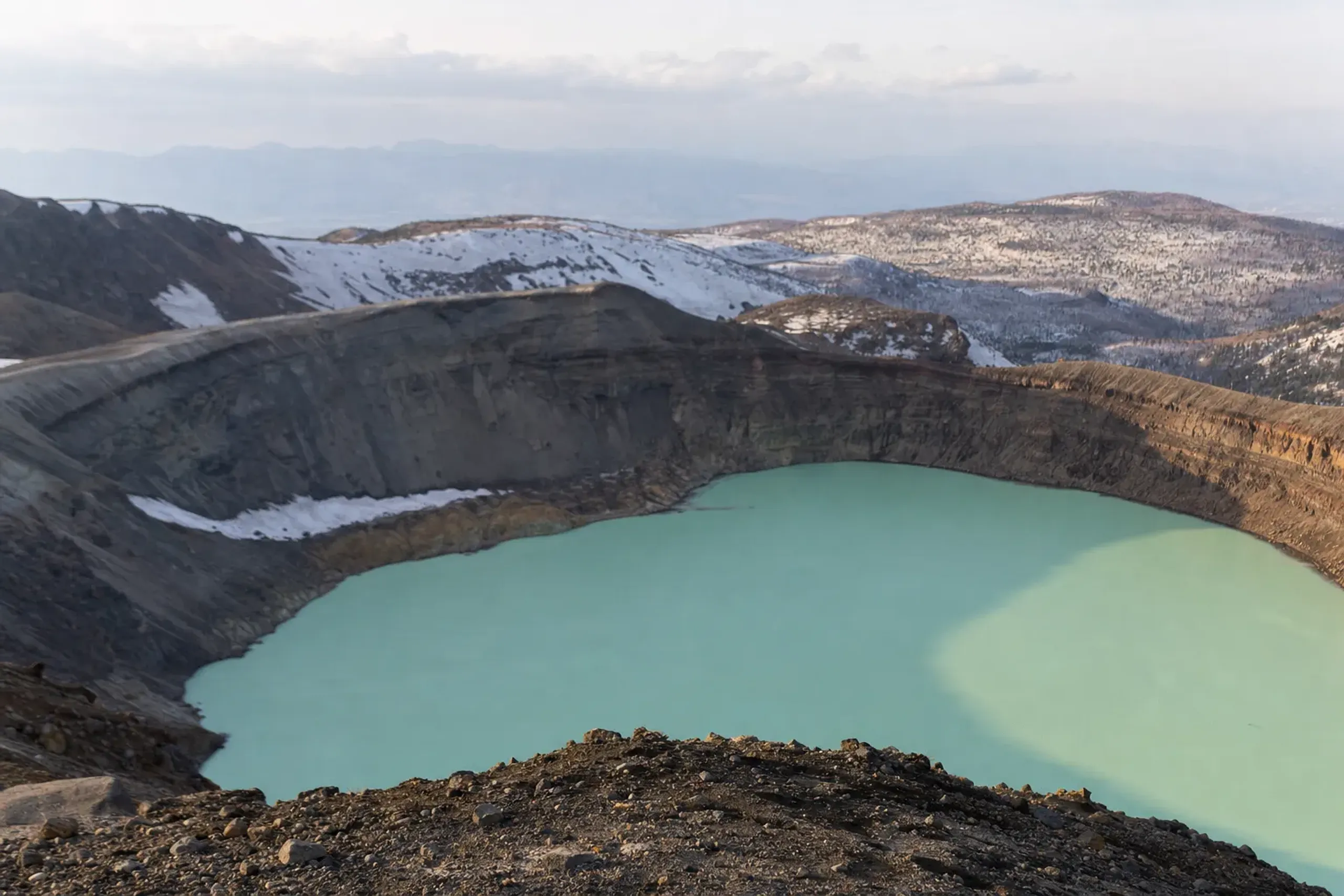 Okama crater lake of Mount Zaō showing its shifting deep-green to opaque-blue mineral water surface