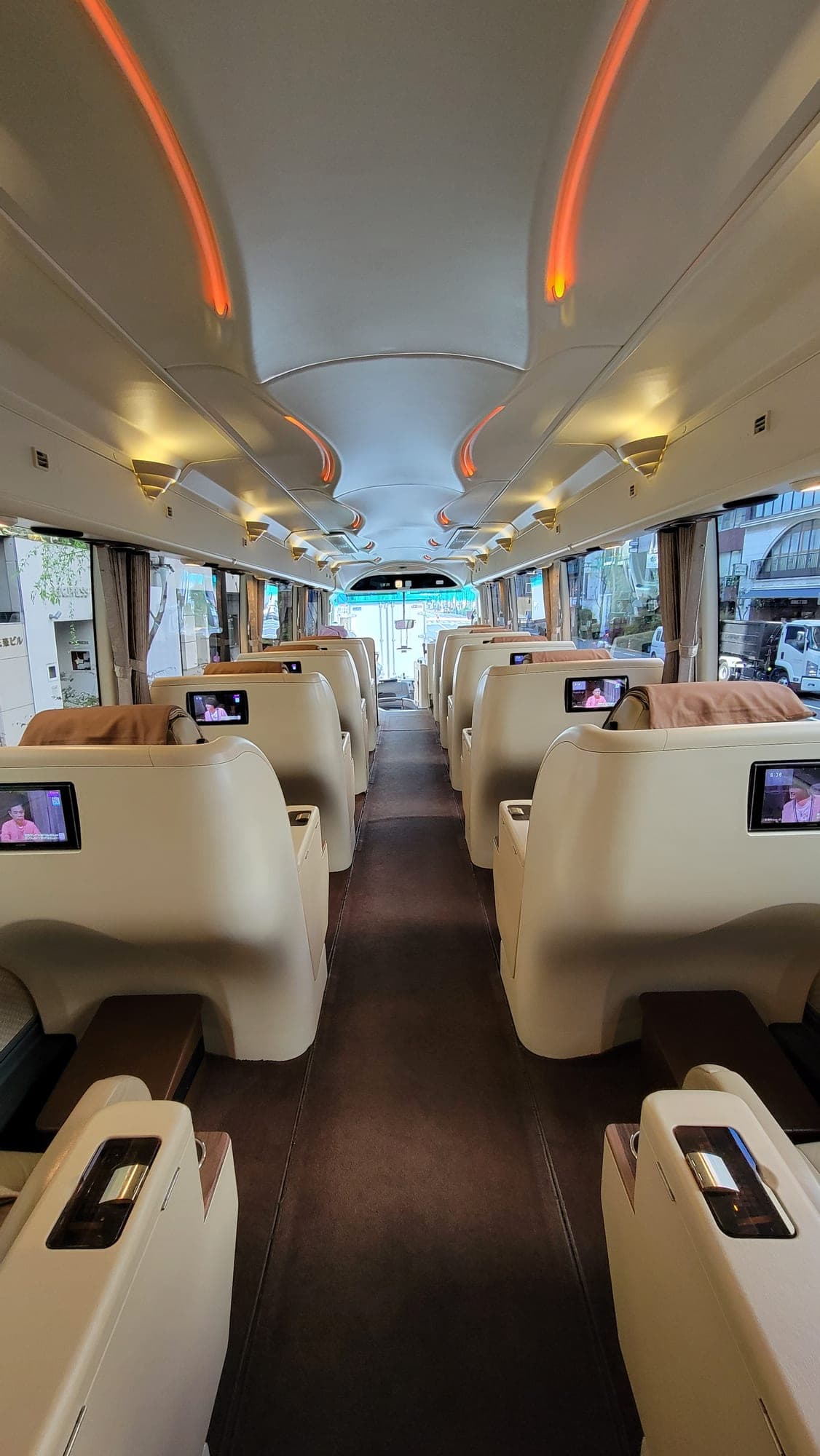 Grand Class Coach salon seats with seat-back screens and lounge spacing