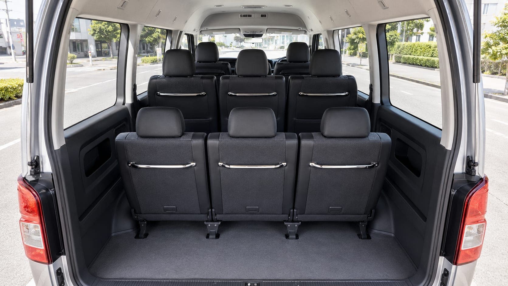 Toyota Hiace Grand Cabin seating rows and luggage bay through the open rear hatch