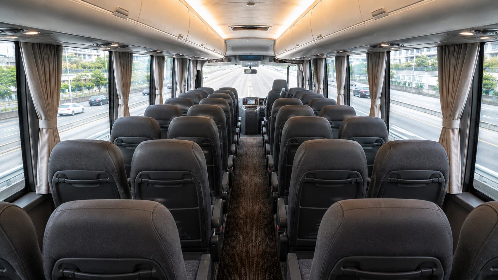 Mid-size coach reclining rows with the expressway outside