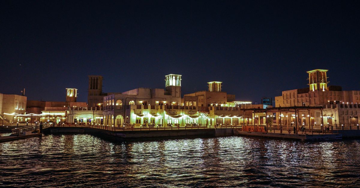 Lantern-lit Arabian Coast area at Tokyo DisneySea at night with guests strolling